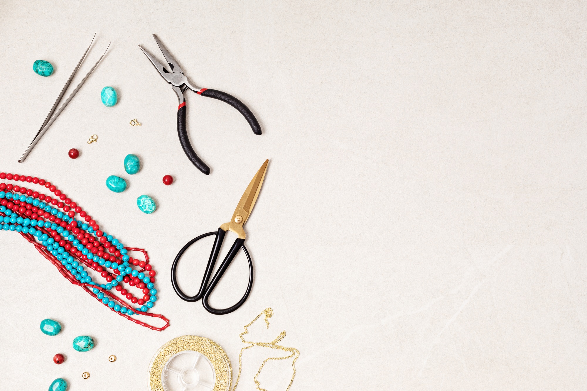 Jewelry making flatlay with semi-precious stone beads and tools