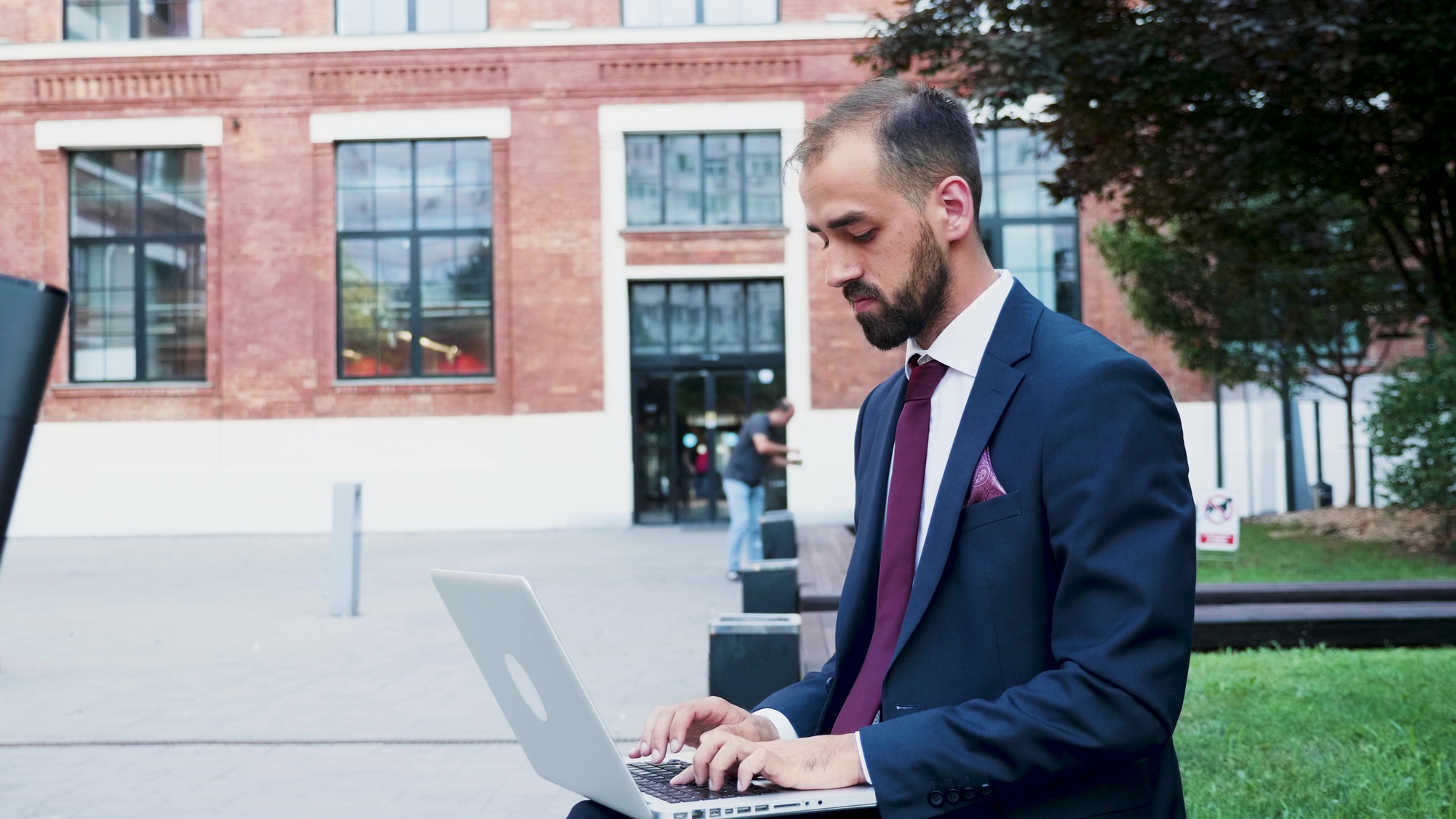 Leader woman sitting on bench holding laptop computer browsing business information