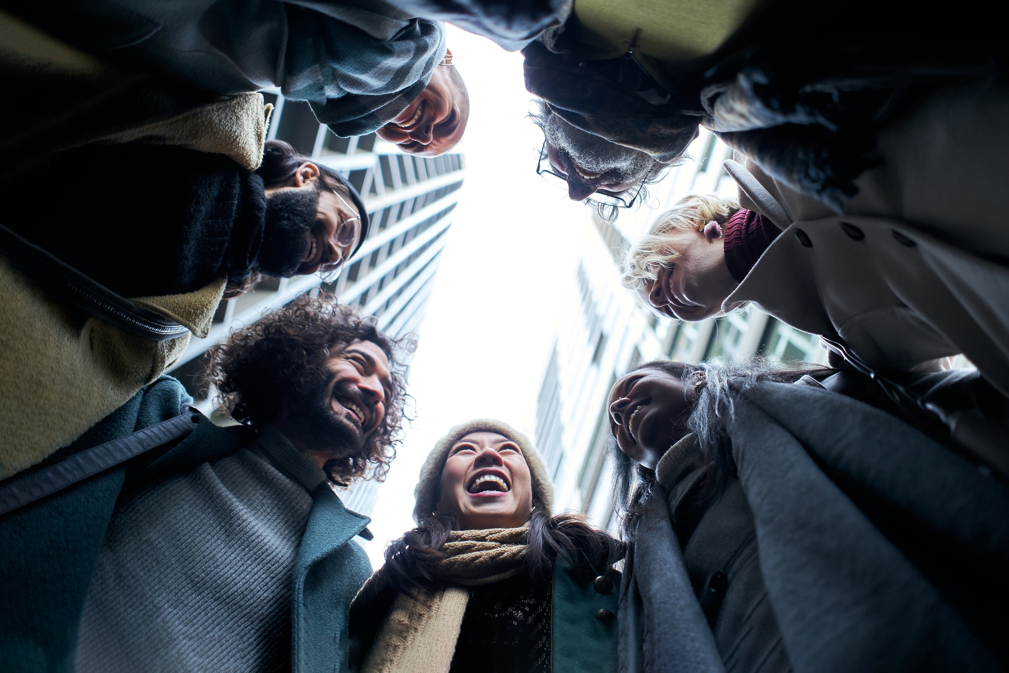 Low angle of a unity group of business people in circle.
