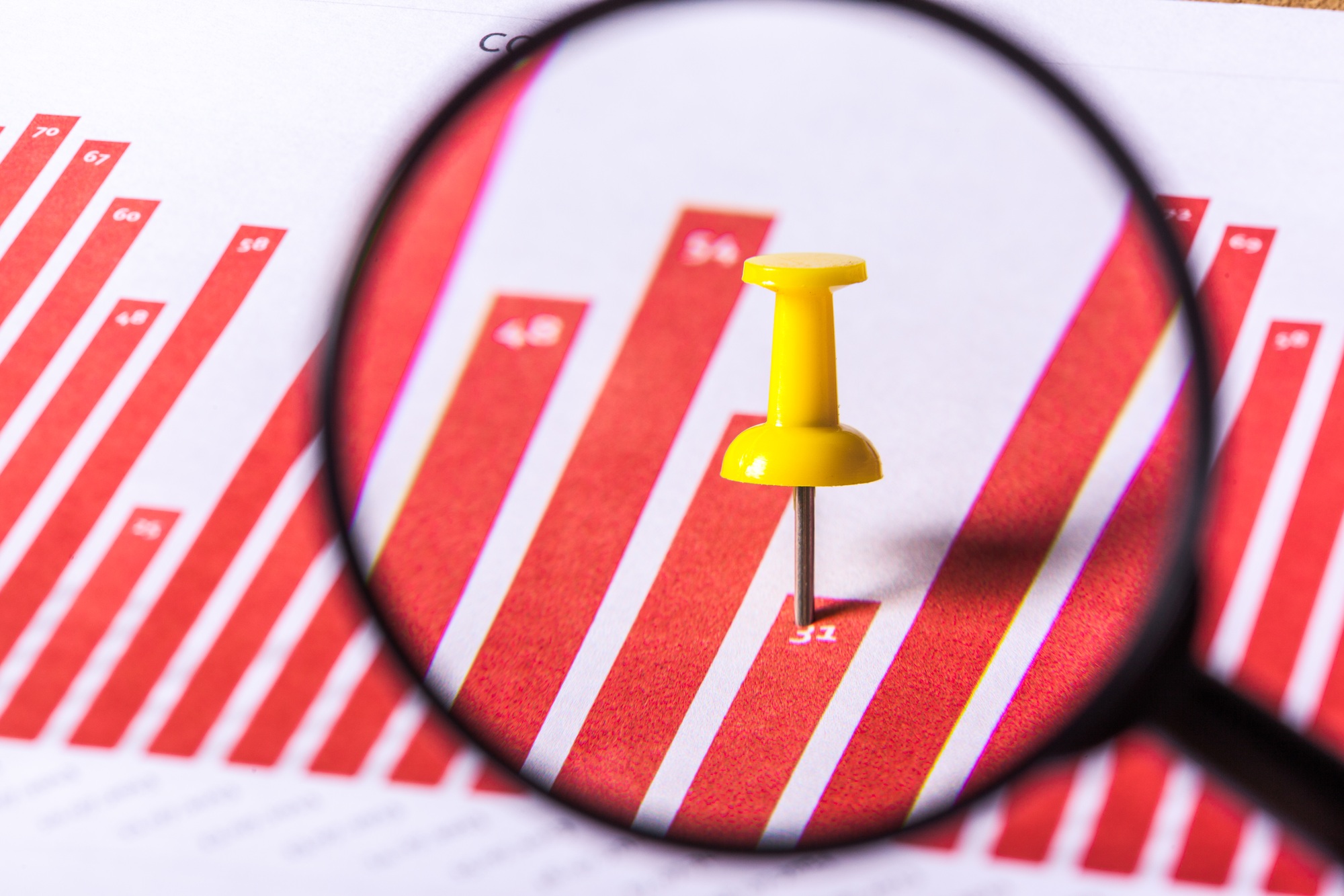 Magnifying glass and business growth graph