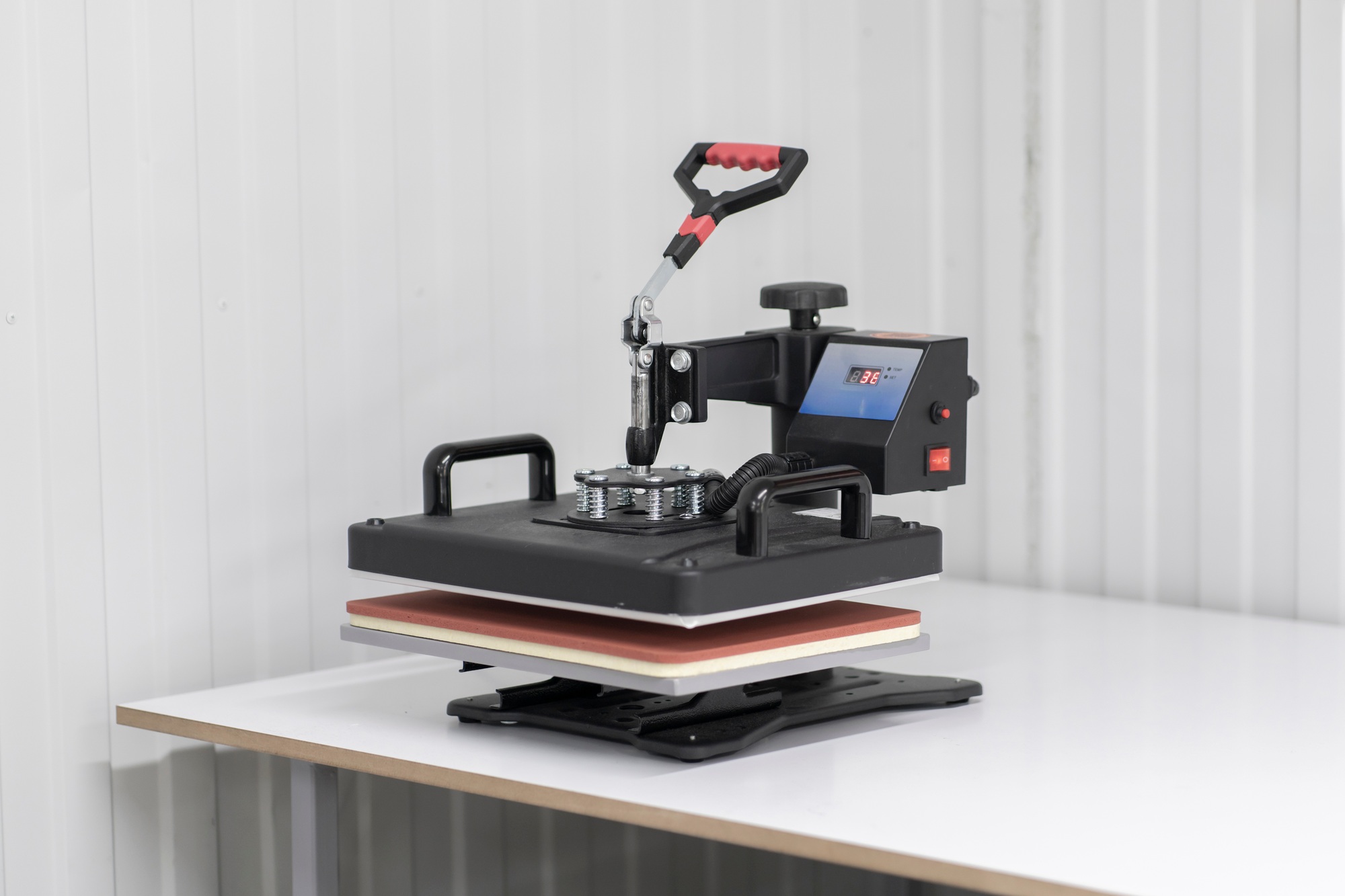 making a print on t-shirt using press in the clothing manufacture