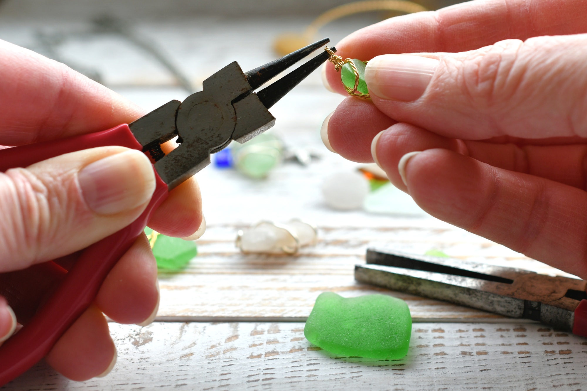 Making jewelry out of green seaglass, sea glass. Using pliers and wire, hobby, hobbies