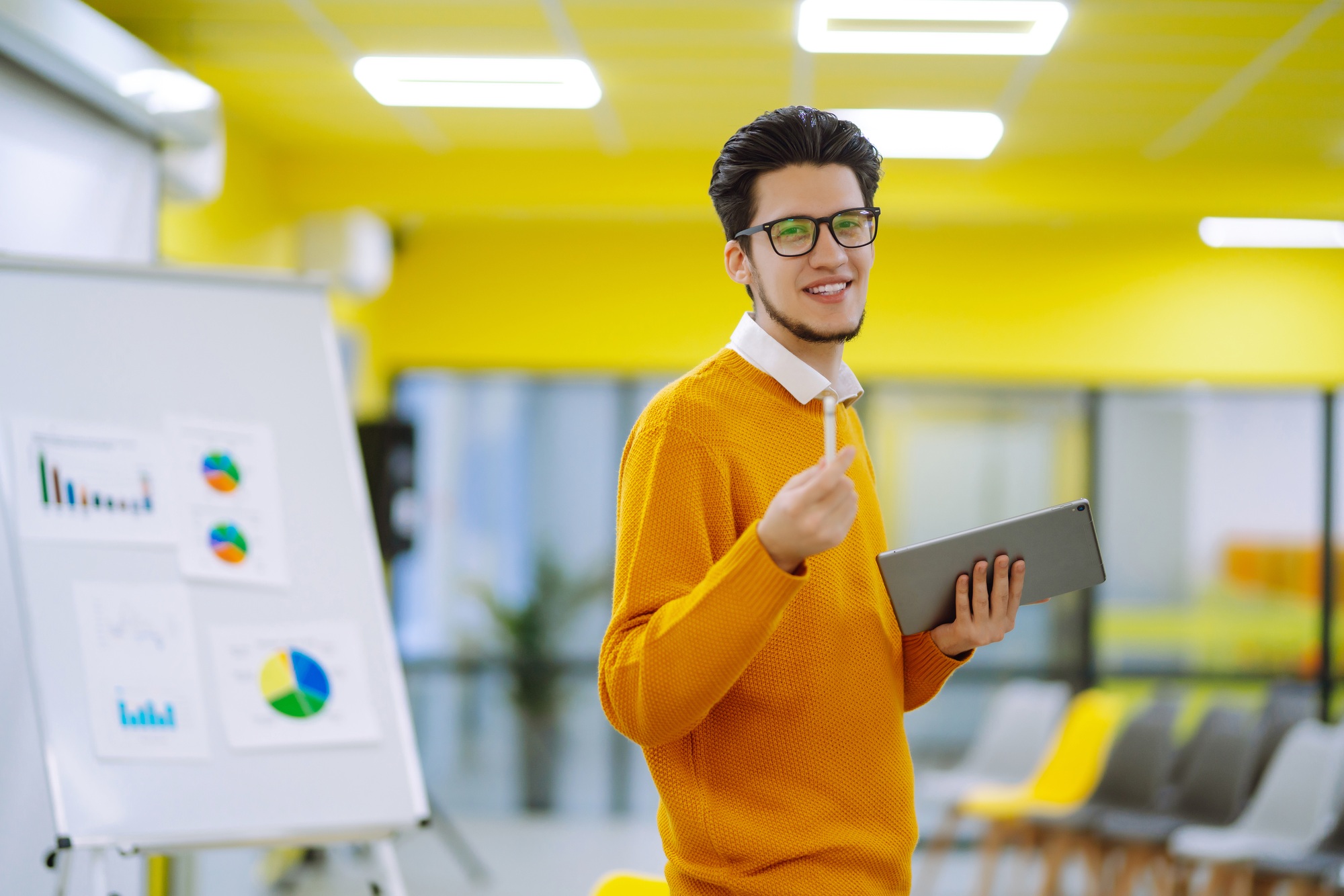 Male business coach speaker giving flipchart presentation