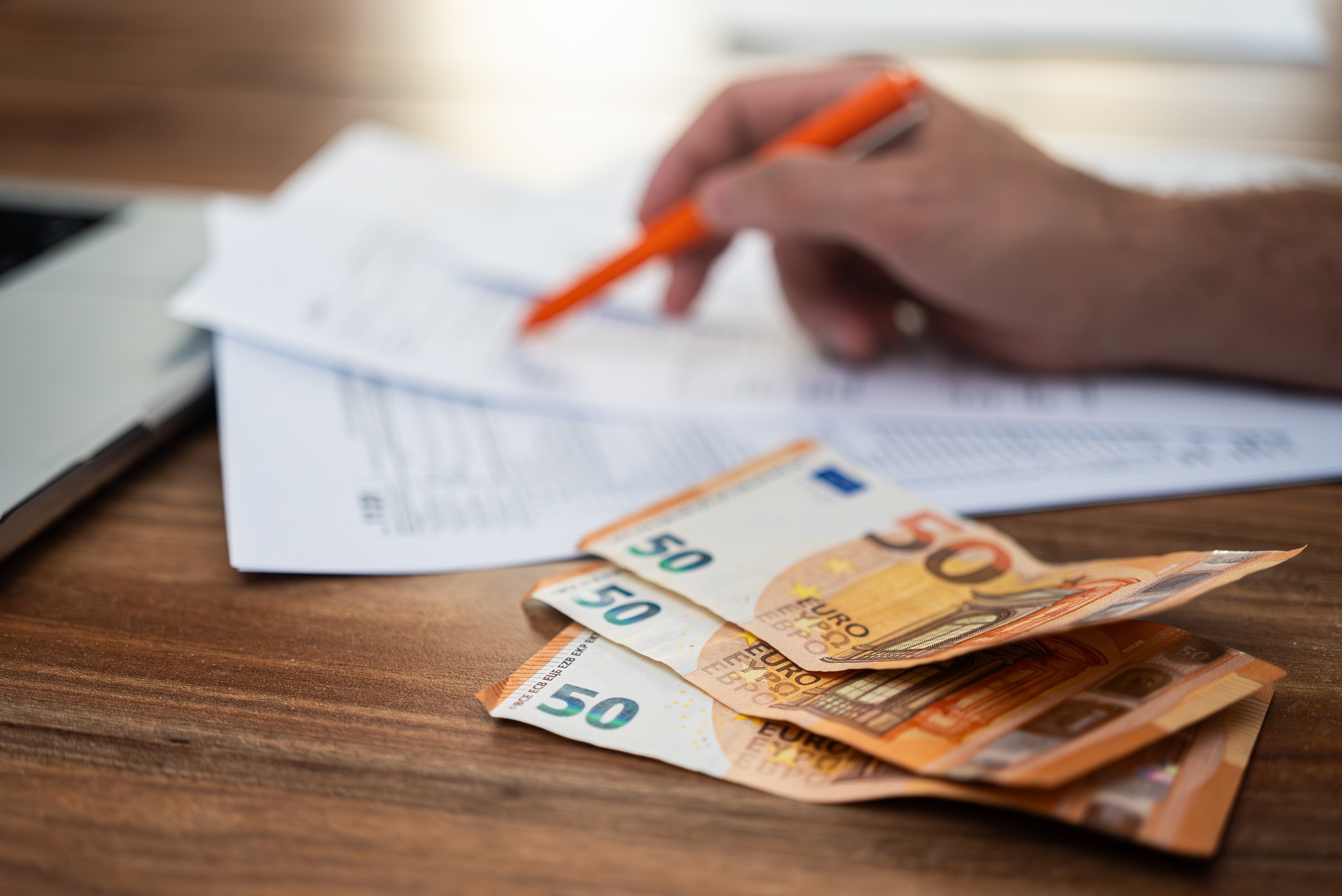 Male freelancer engages in filling tax forms process carefully examining strict requirements