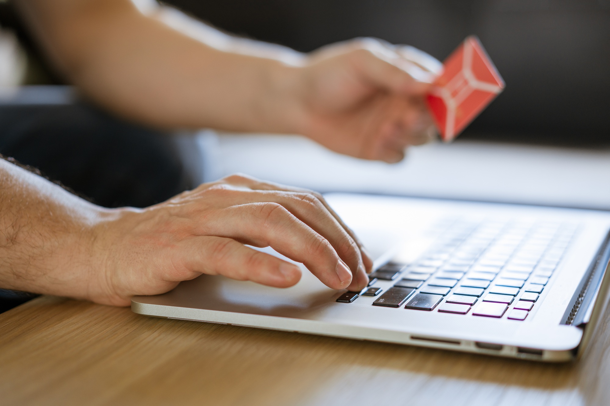 male hands hold credit card with laptop, concept of online shopping in online store