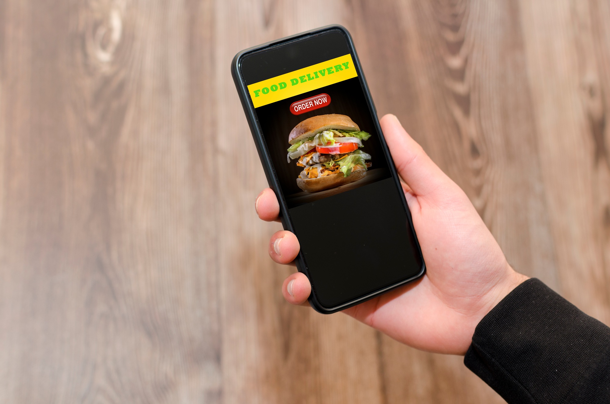 Man choosing a meal on food delivery app. Hamburguer, fast food.