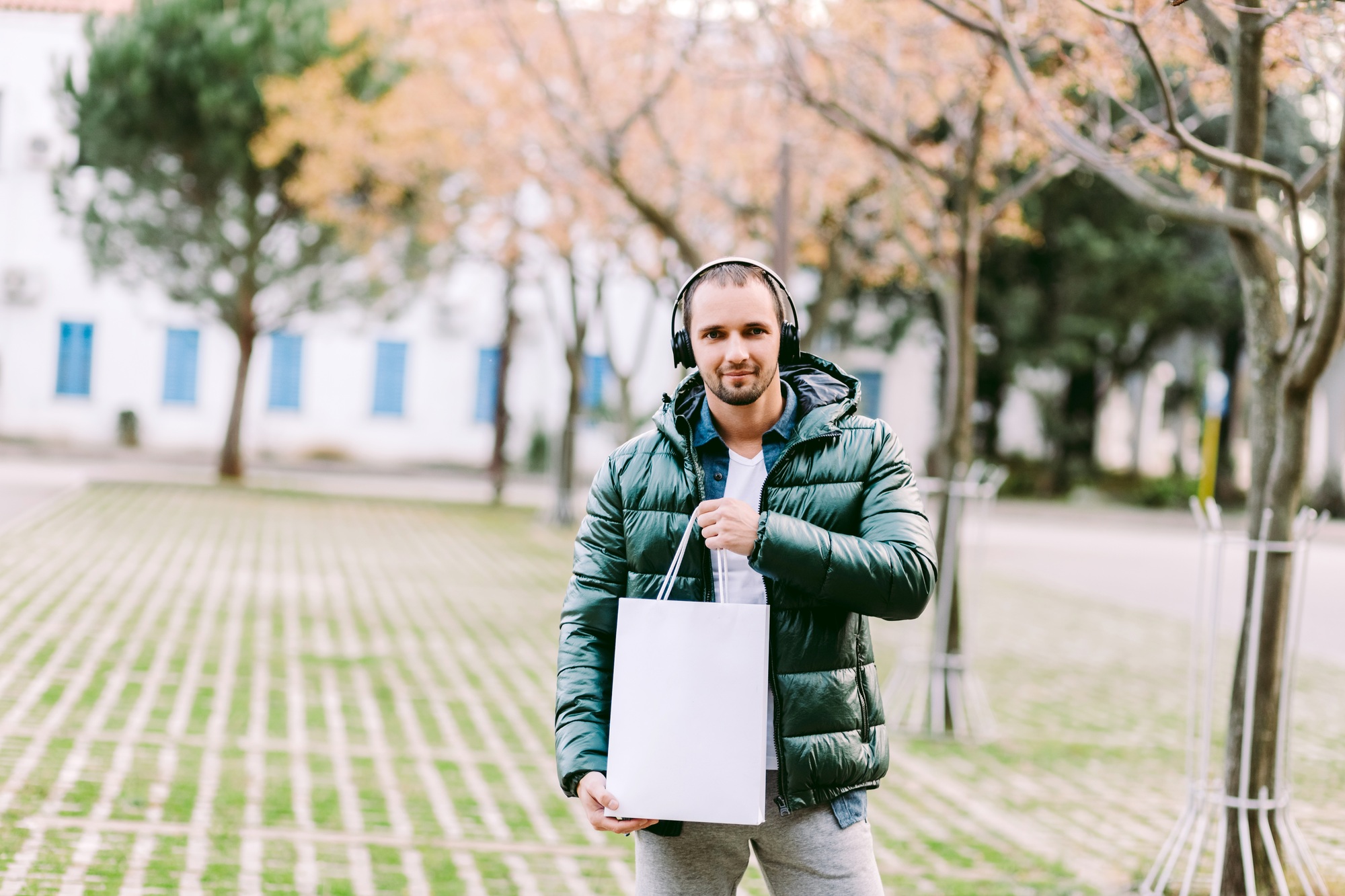 man holding White paper bag and white t-shirt mockup