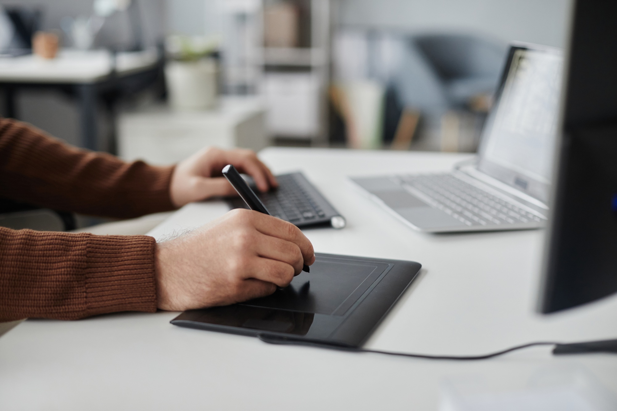 Man Using Pen Tablet Editing Photo or Video at Office Workplace