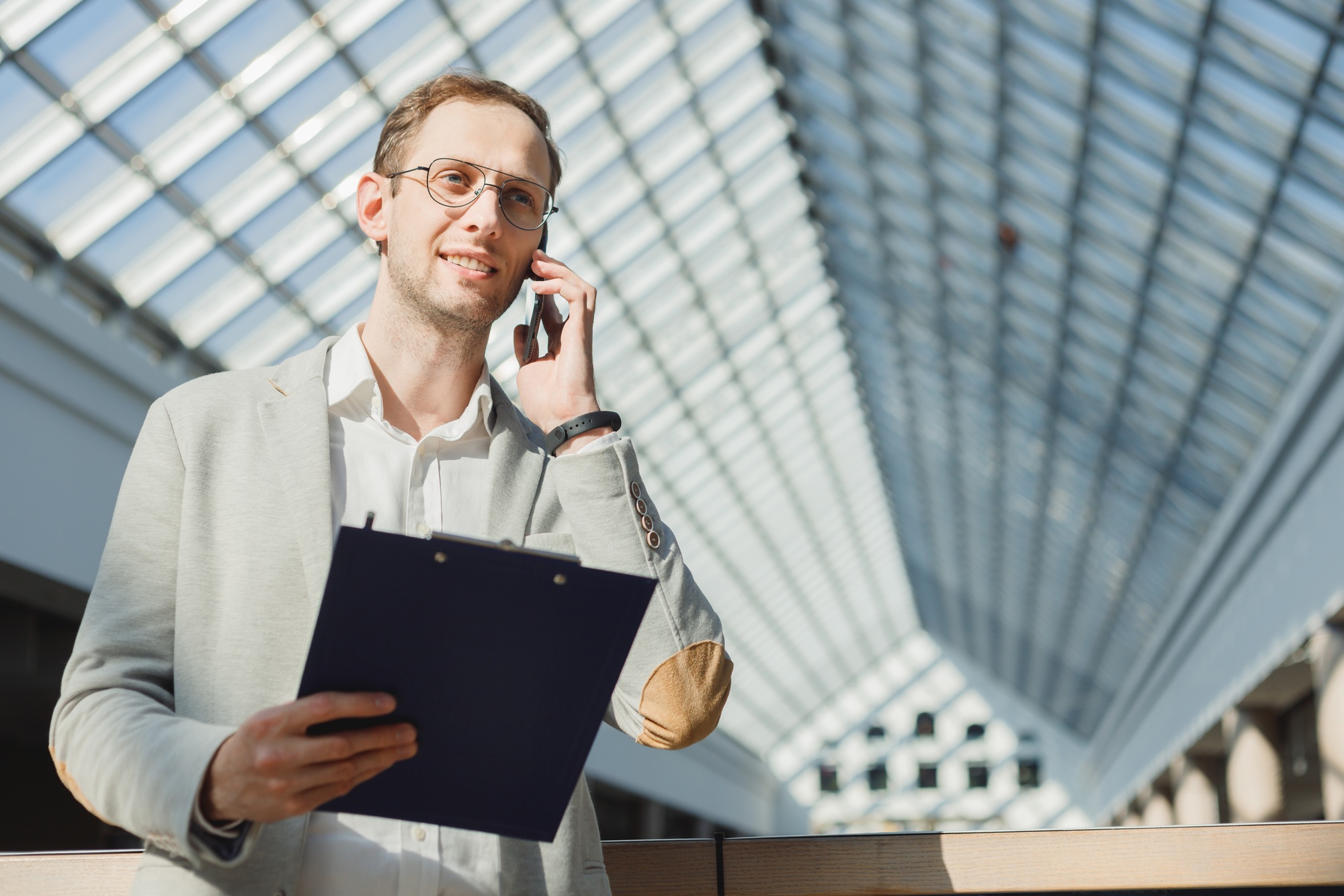 Man with folder makes survey on mobile, an anonymous survey, cold calls, business proposal, sales