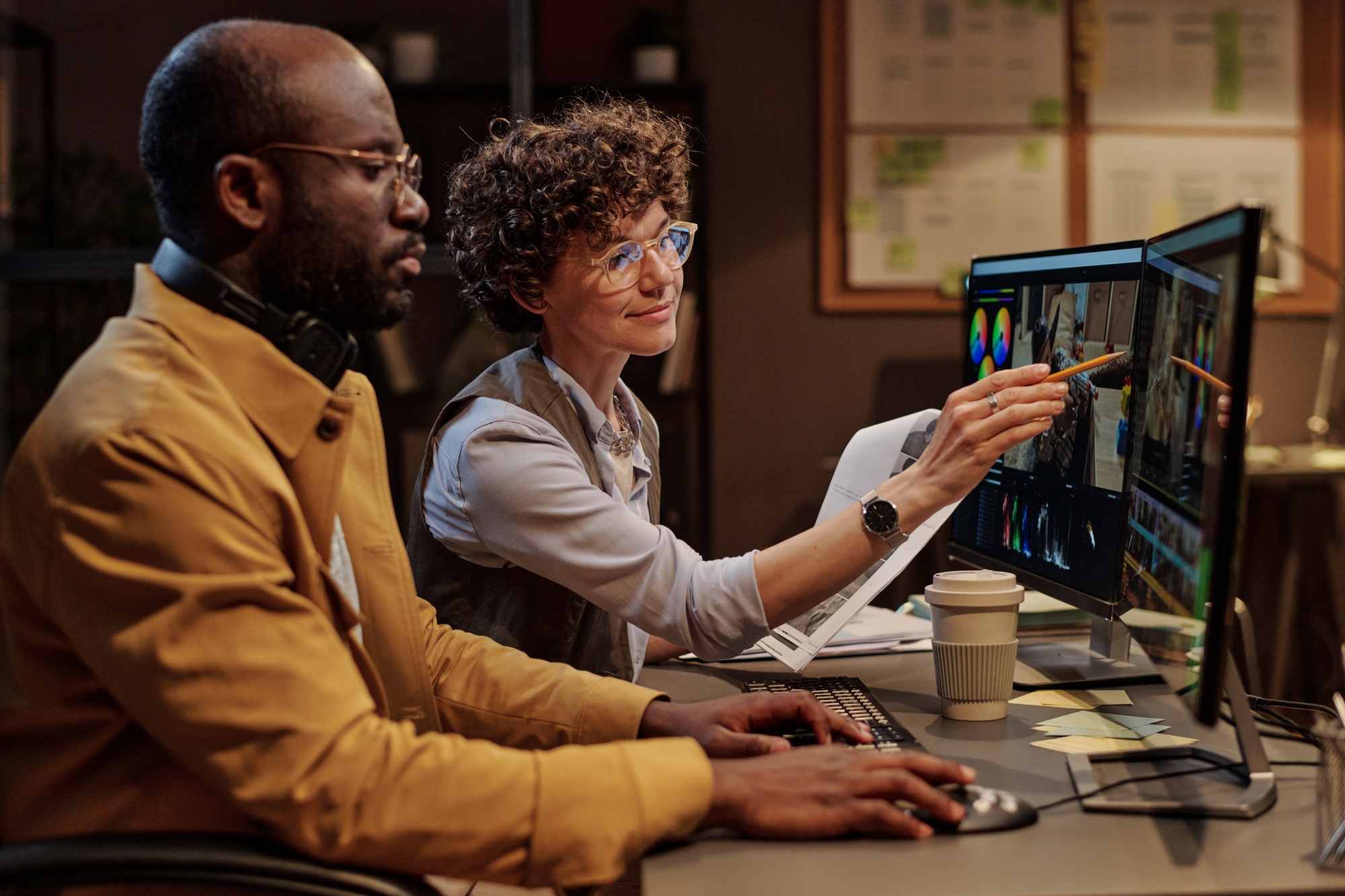 Manager discussing montage with colorist