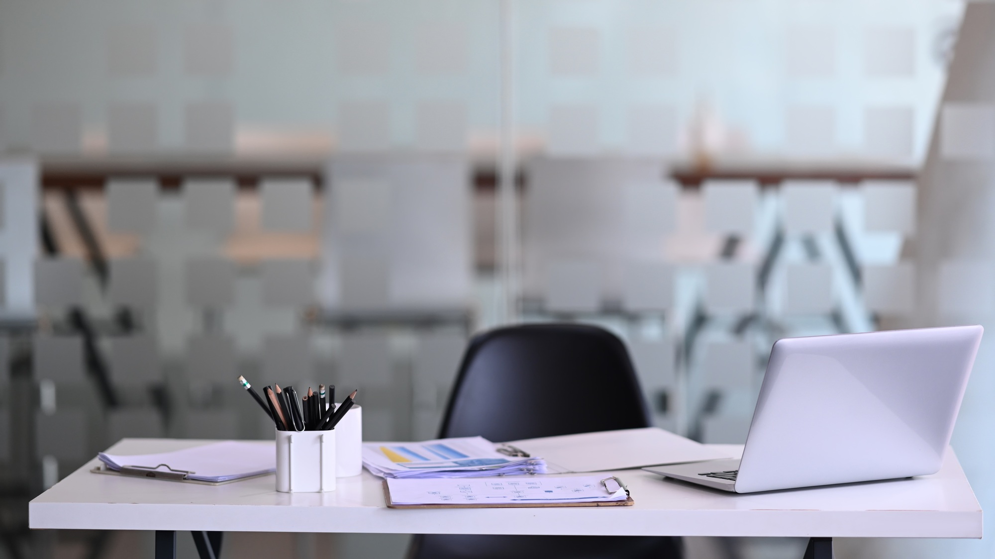 Manager working desk with laptop computer, document, paperwork and office suppliers.