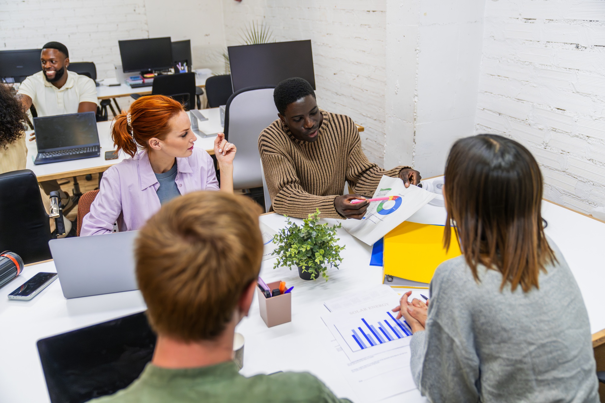 Marketing professionals discussing growth strategies in coworking space