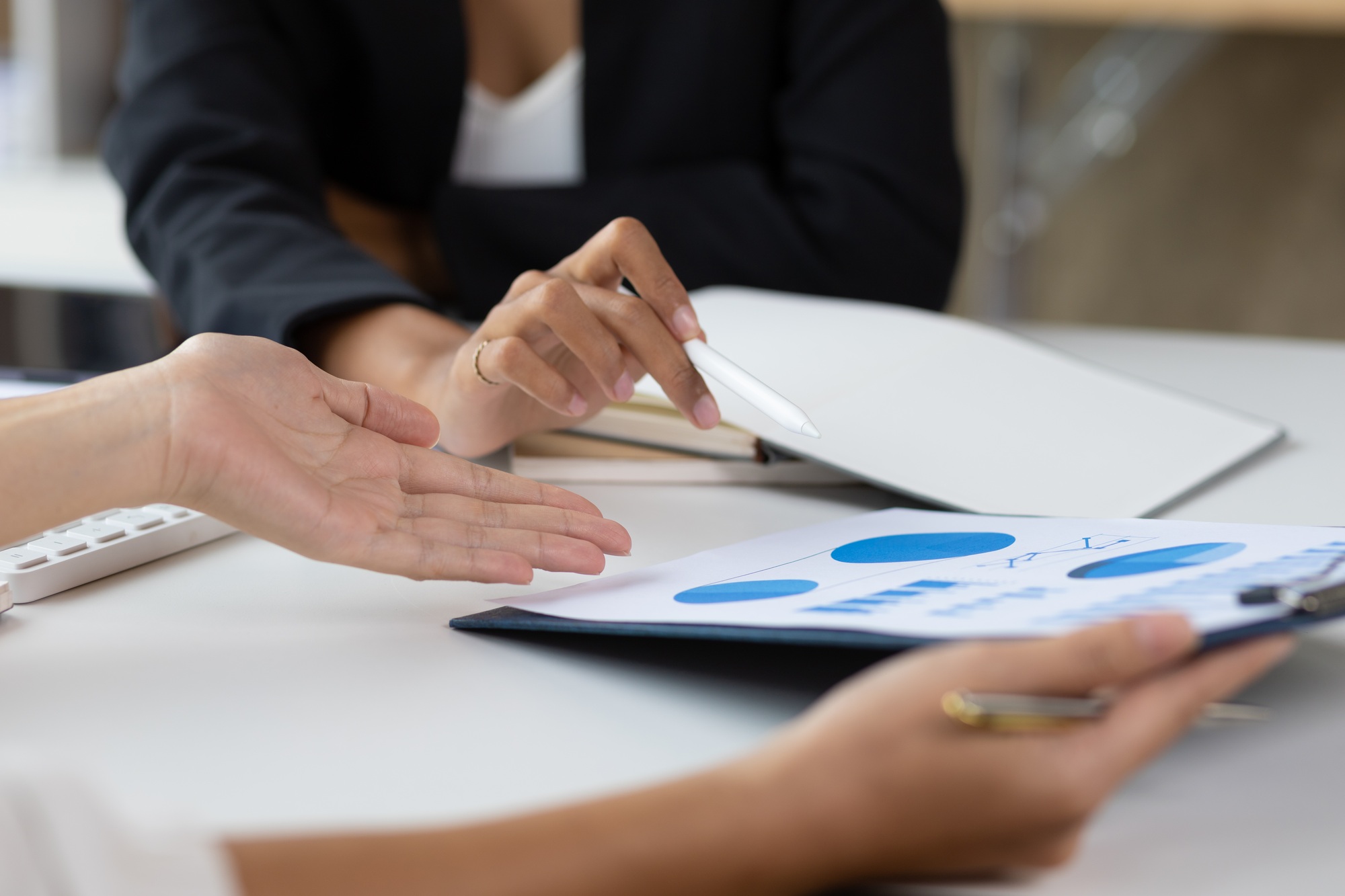Meeting with colleagues to discuss financial reports for strategic analysis and business planning.
