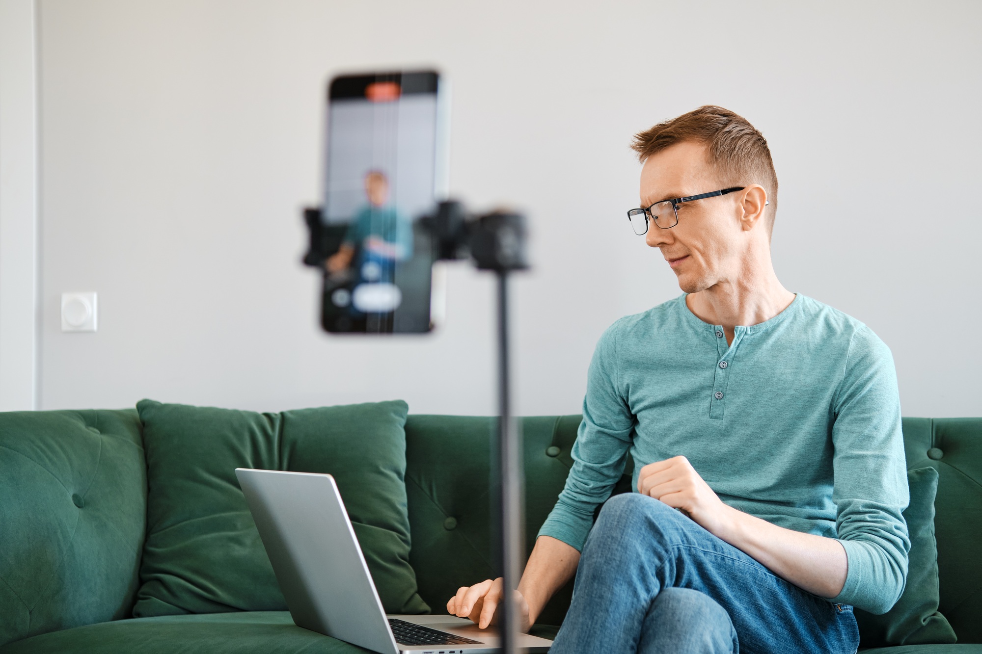 Middle-aged man leads an online broadcast and answers questions from the audience