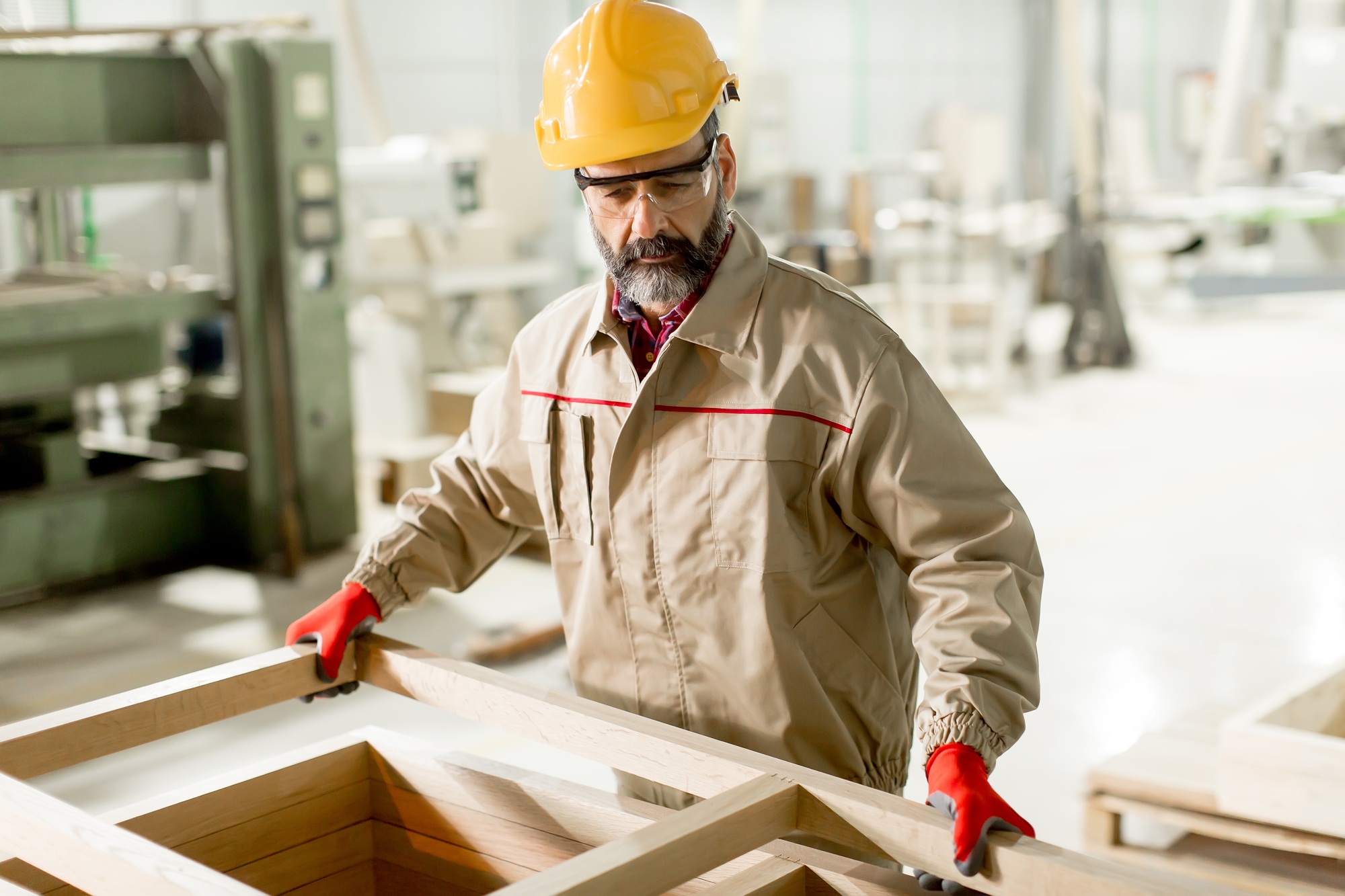 Middle aged worker working in the furniture factory