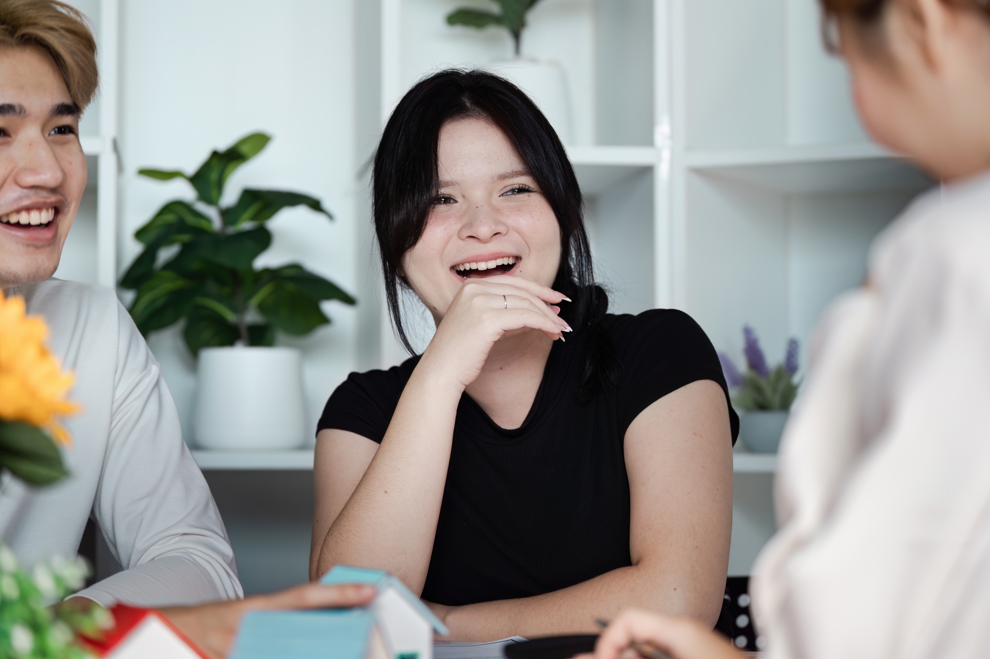 Modern Real Estate Meeting with Happy Young Professionals Discussing Property Opportunities in a