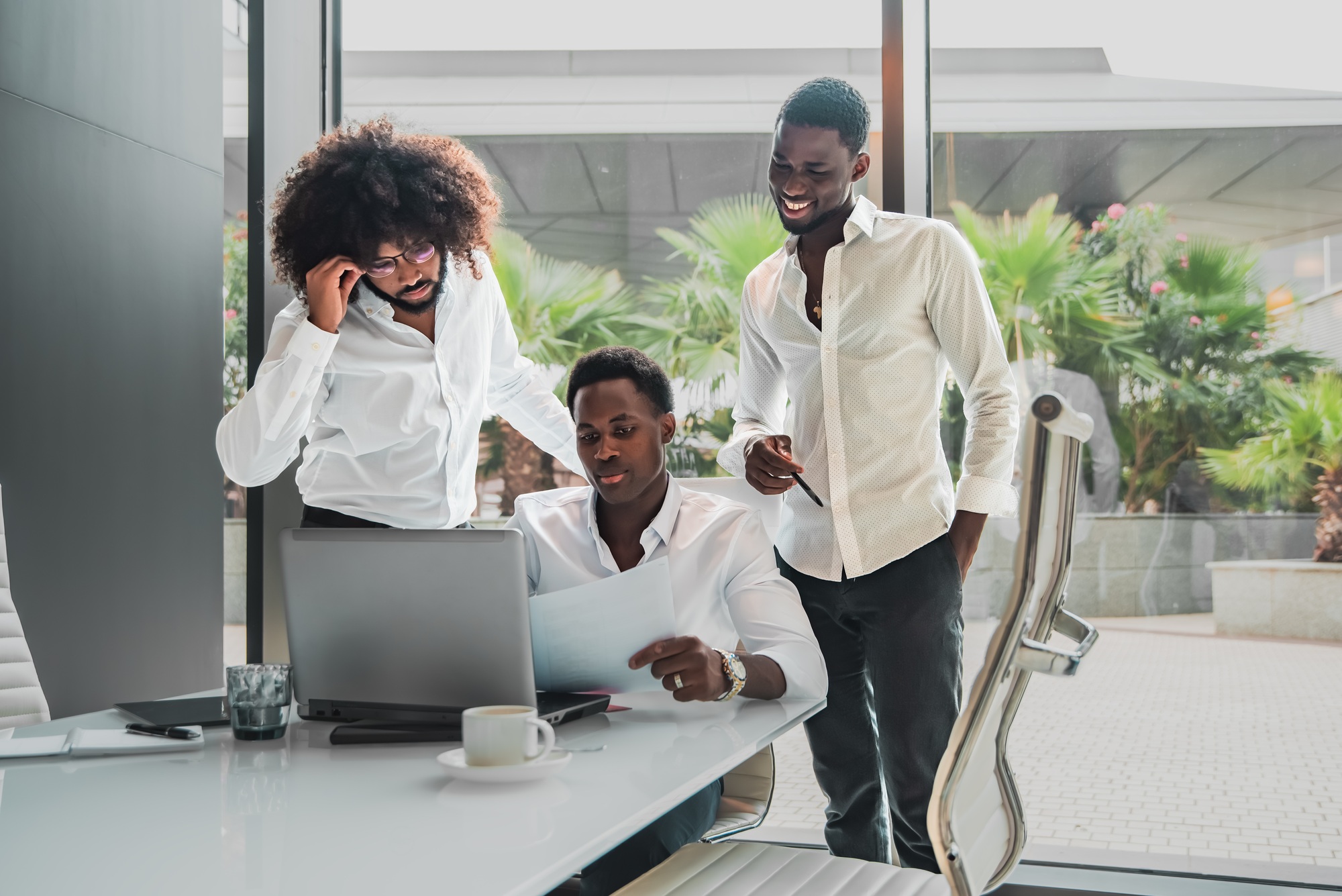 multi ethnic Business Team Engaged in Strategic Discussion with Laptop and Documents in Office