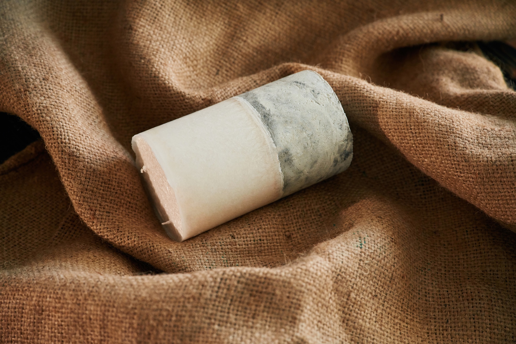 On brown cloth. Handmade beautiful decorative candle on the background