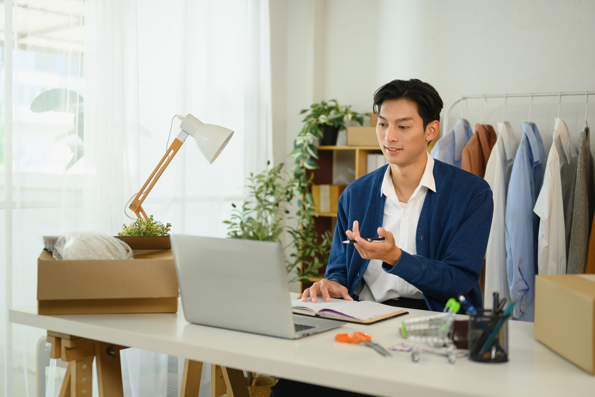 Online store owner working on orders and inventory at home office
