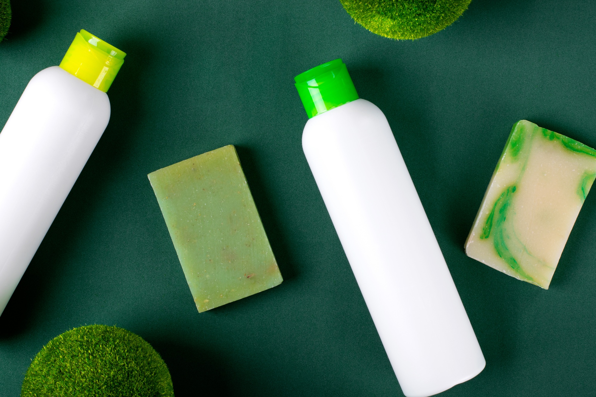 Organic body care products on green. Shower gel and handmade soap