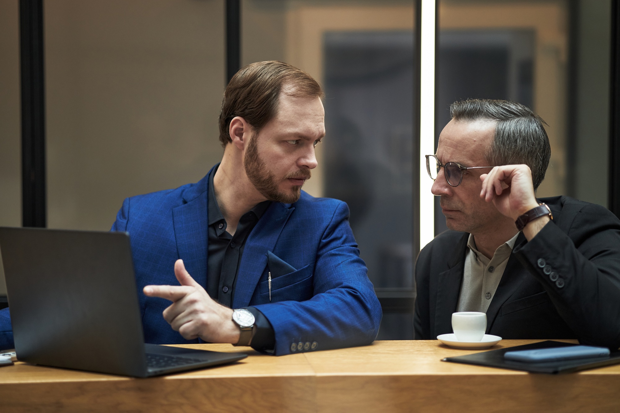 Partners Discussing Business Strategies in Modern Office Setting