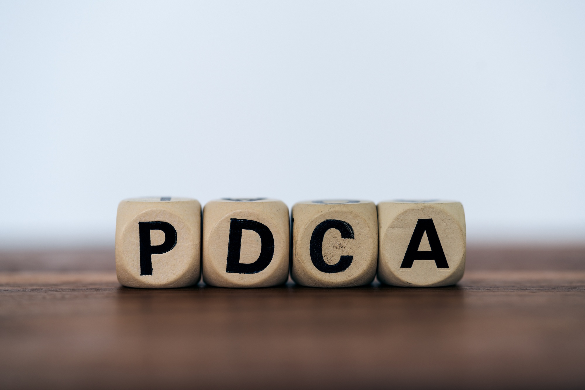 PDCA with wooden cubes. Business improvement strategy concept. copy space