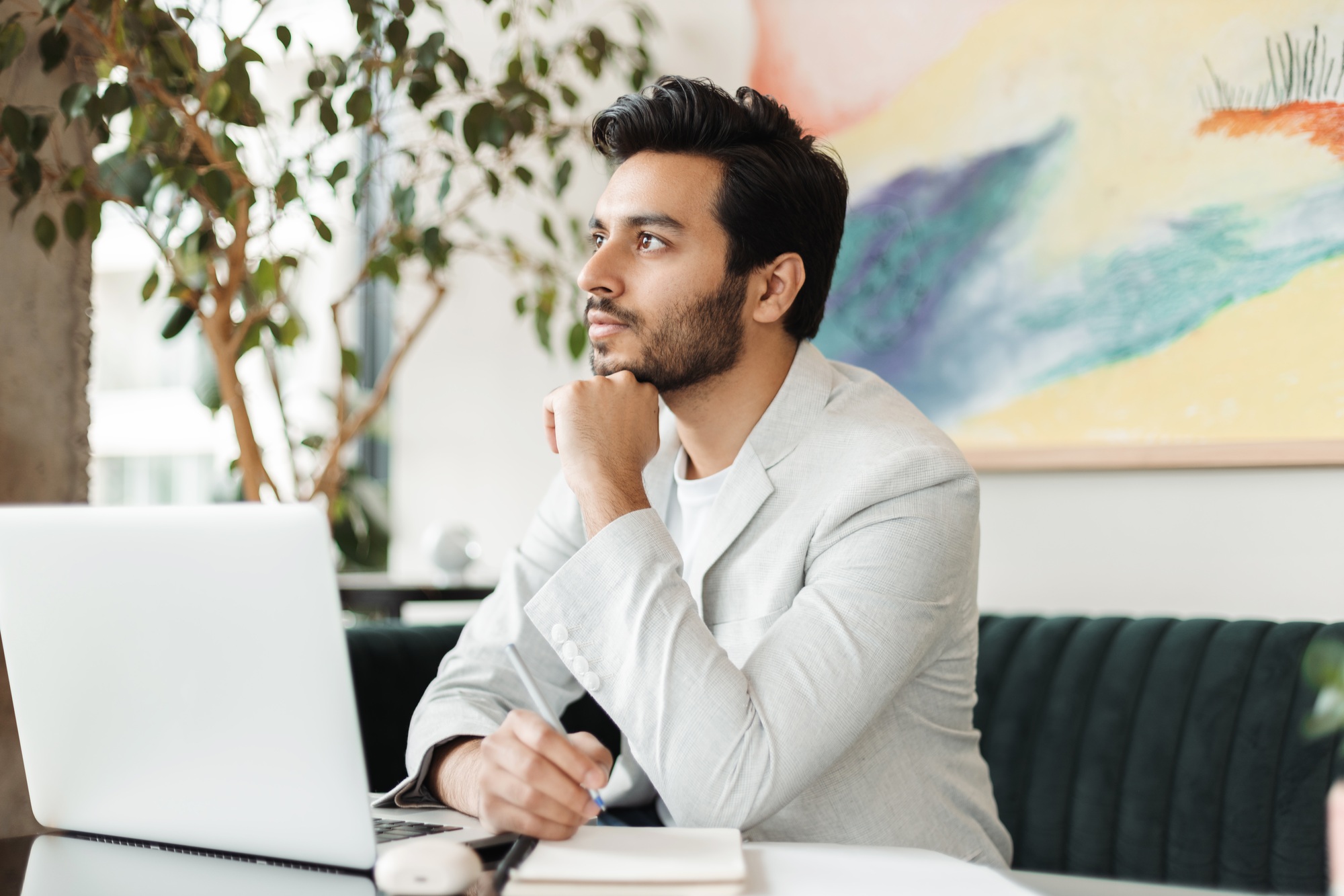 Pensive businessman planning strategy in modern office setting
