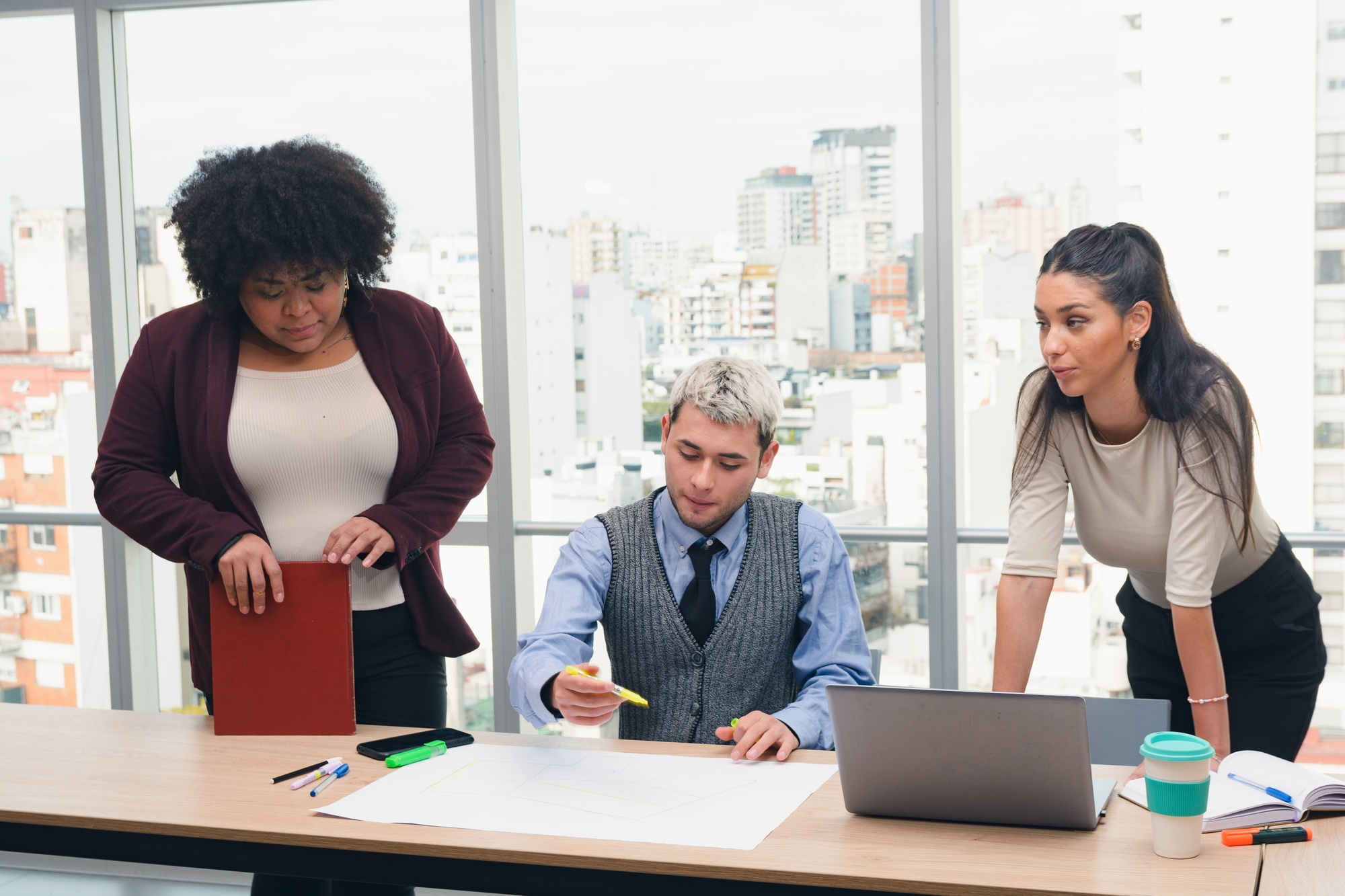 People working in co-working creating strategic business plans and routes