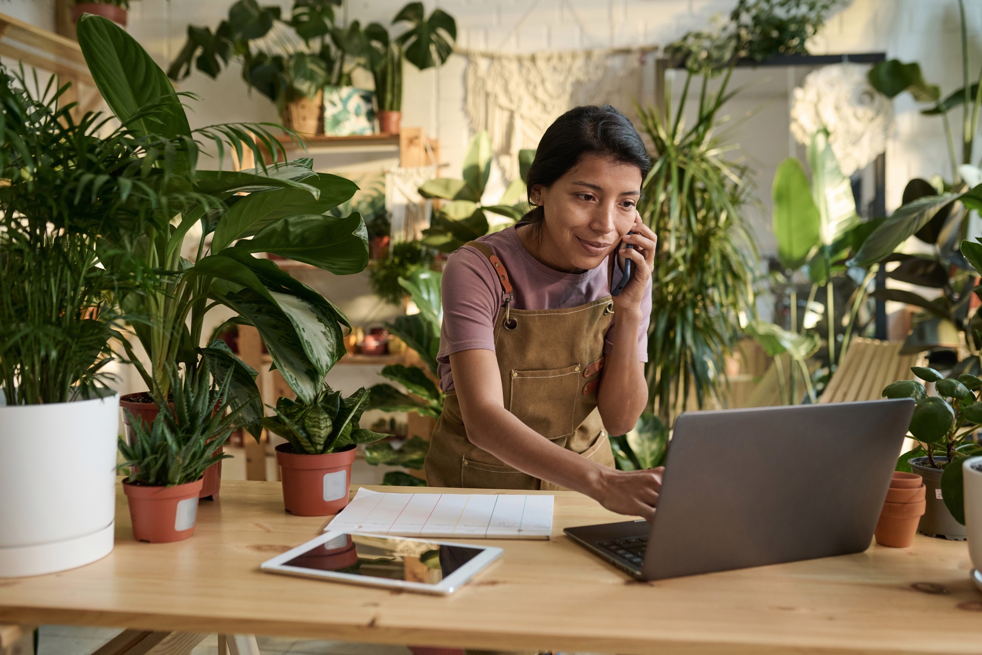 Plant Shop Owner Making Sales Using Technologies