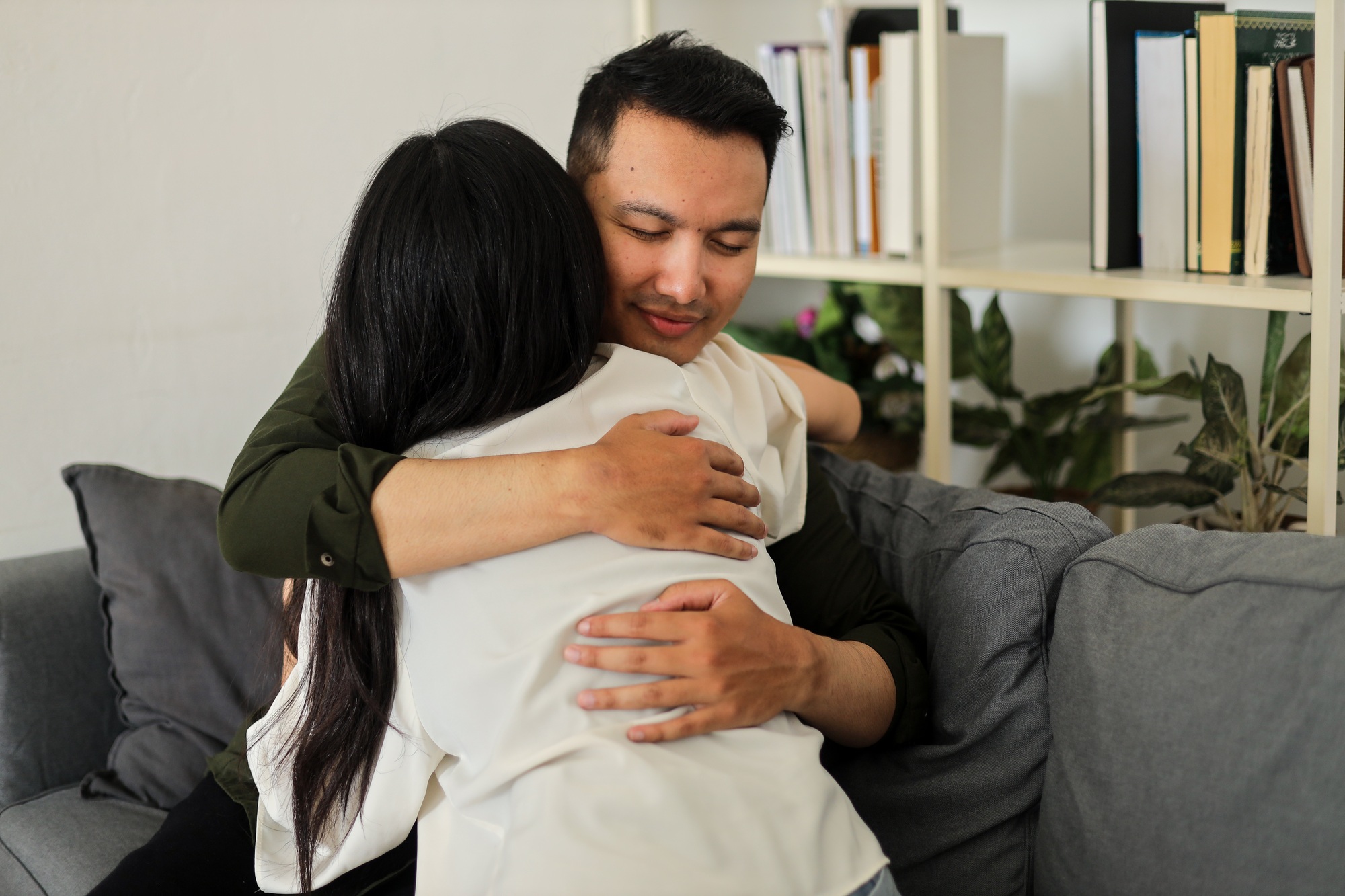 Pleased man hugging woman wife feeling support, celebrating goal achievement.