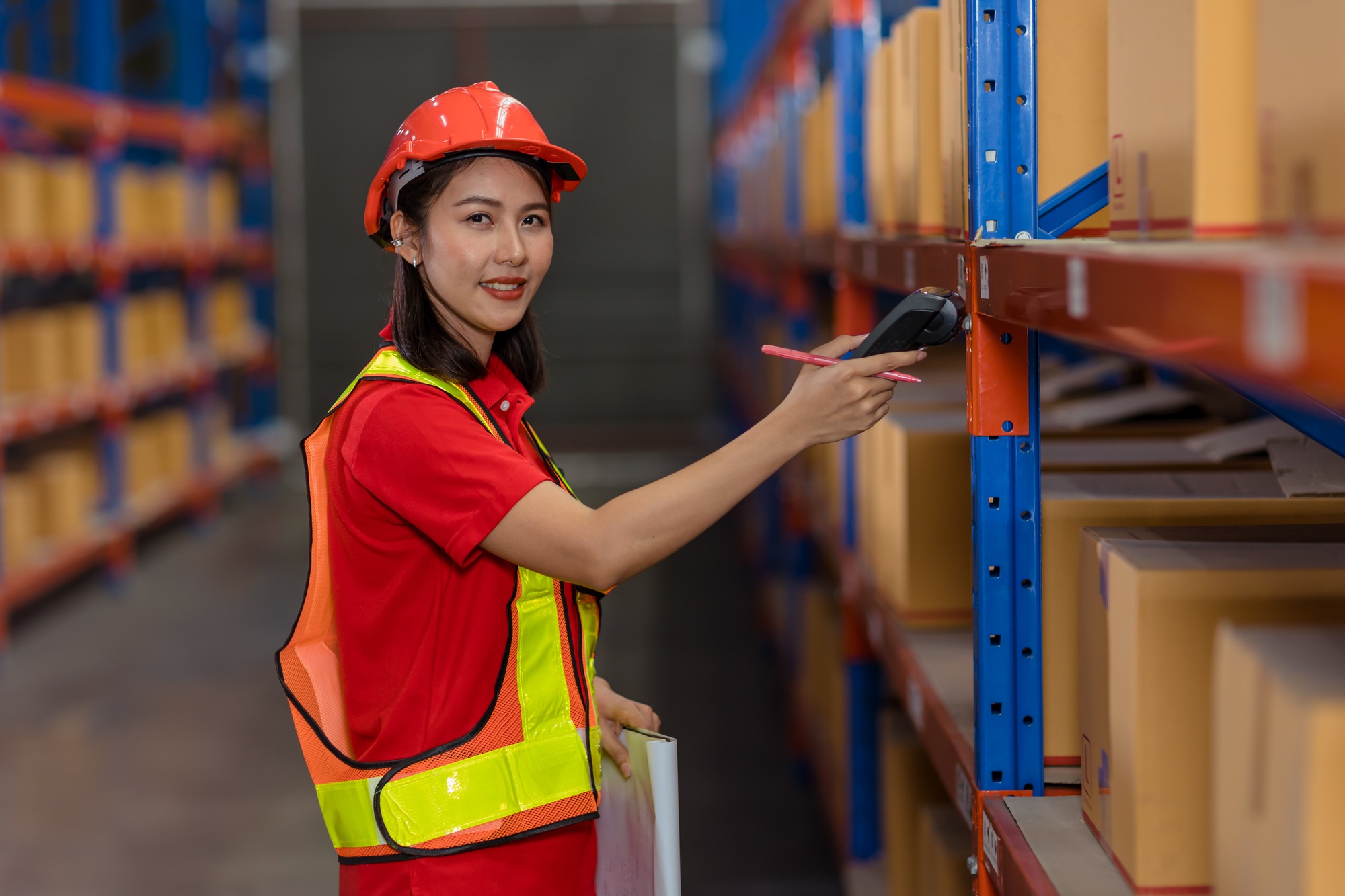 Portrait Asian worker warehouse stock control staff work checking inventory