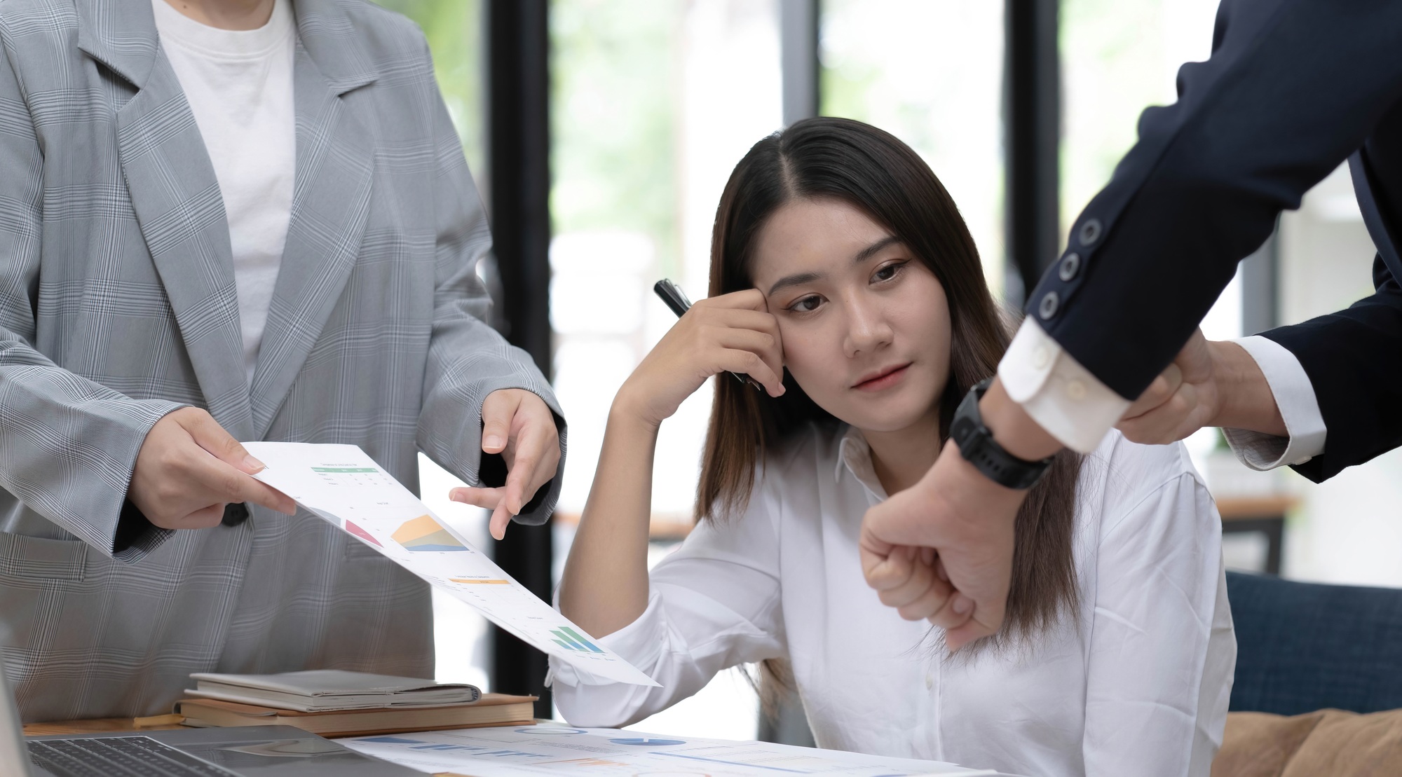 Pretty young Asian female business employee working and planning the marketing campaign with her