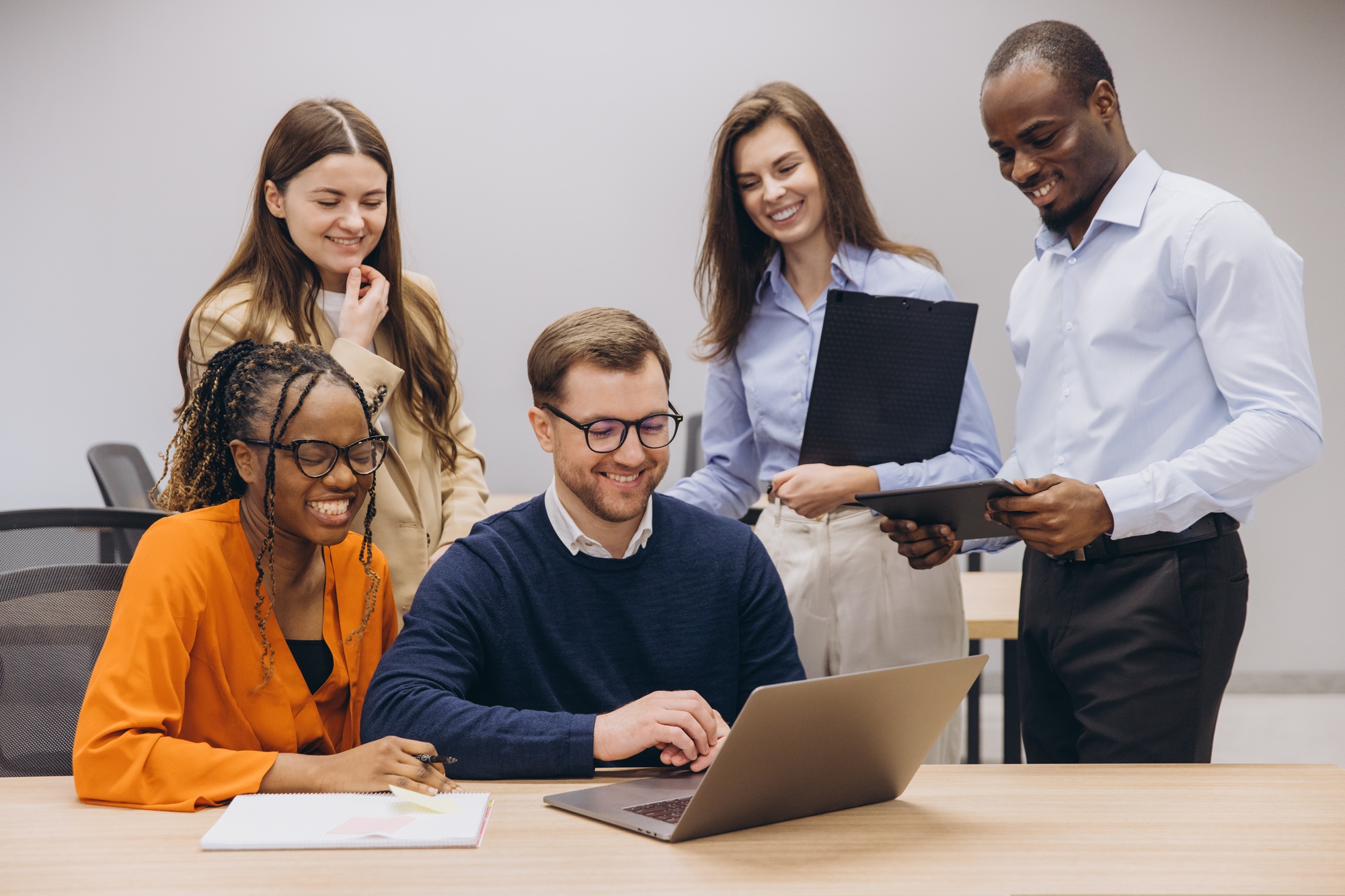 Professional team collaborating, utilizing digital tools for seamless workflow in modern office.