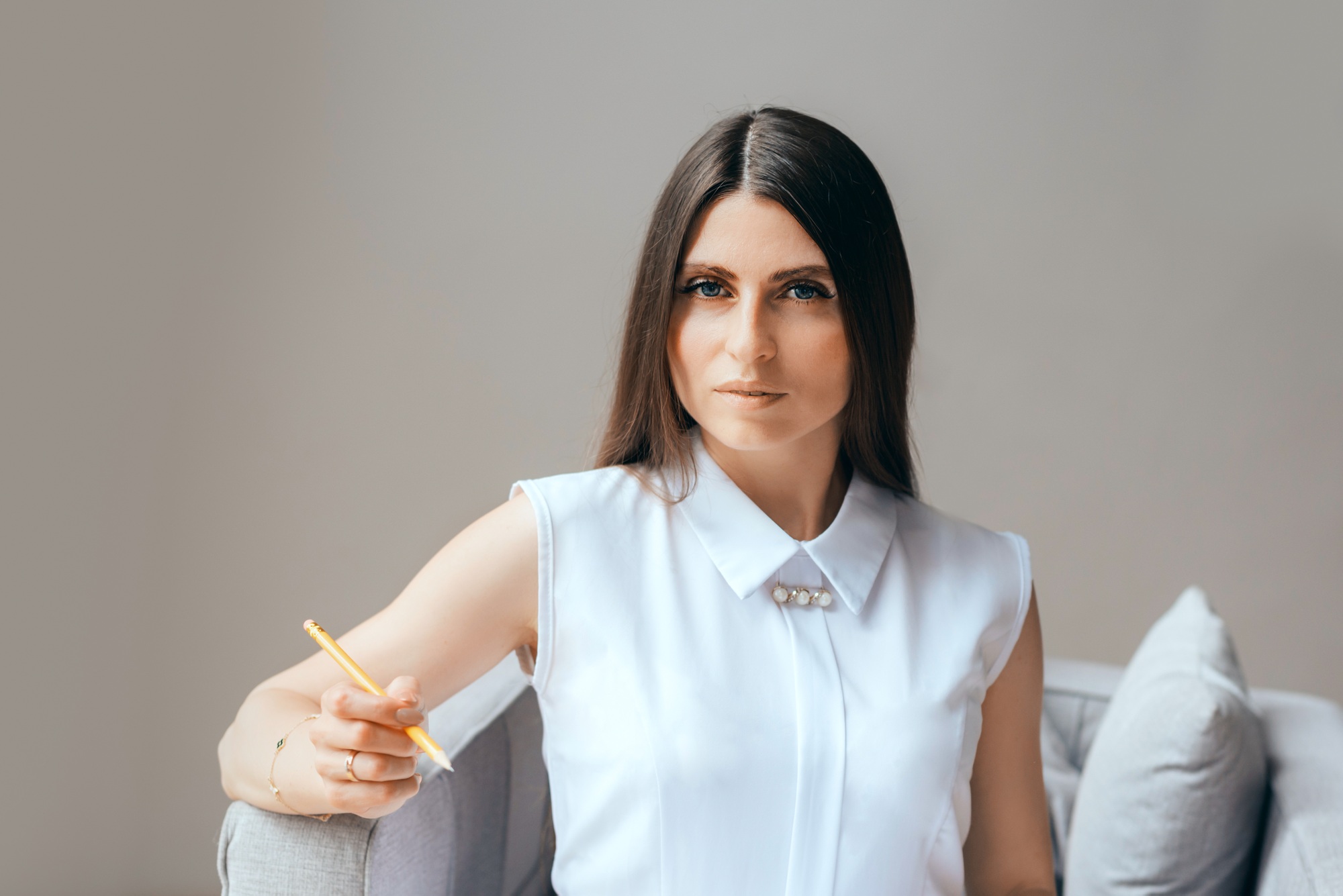 professional woman holding pen, conveying themes of leadership, expertise corporate environment