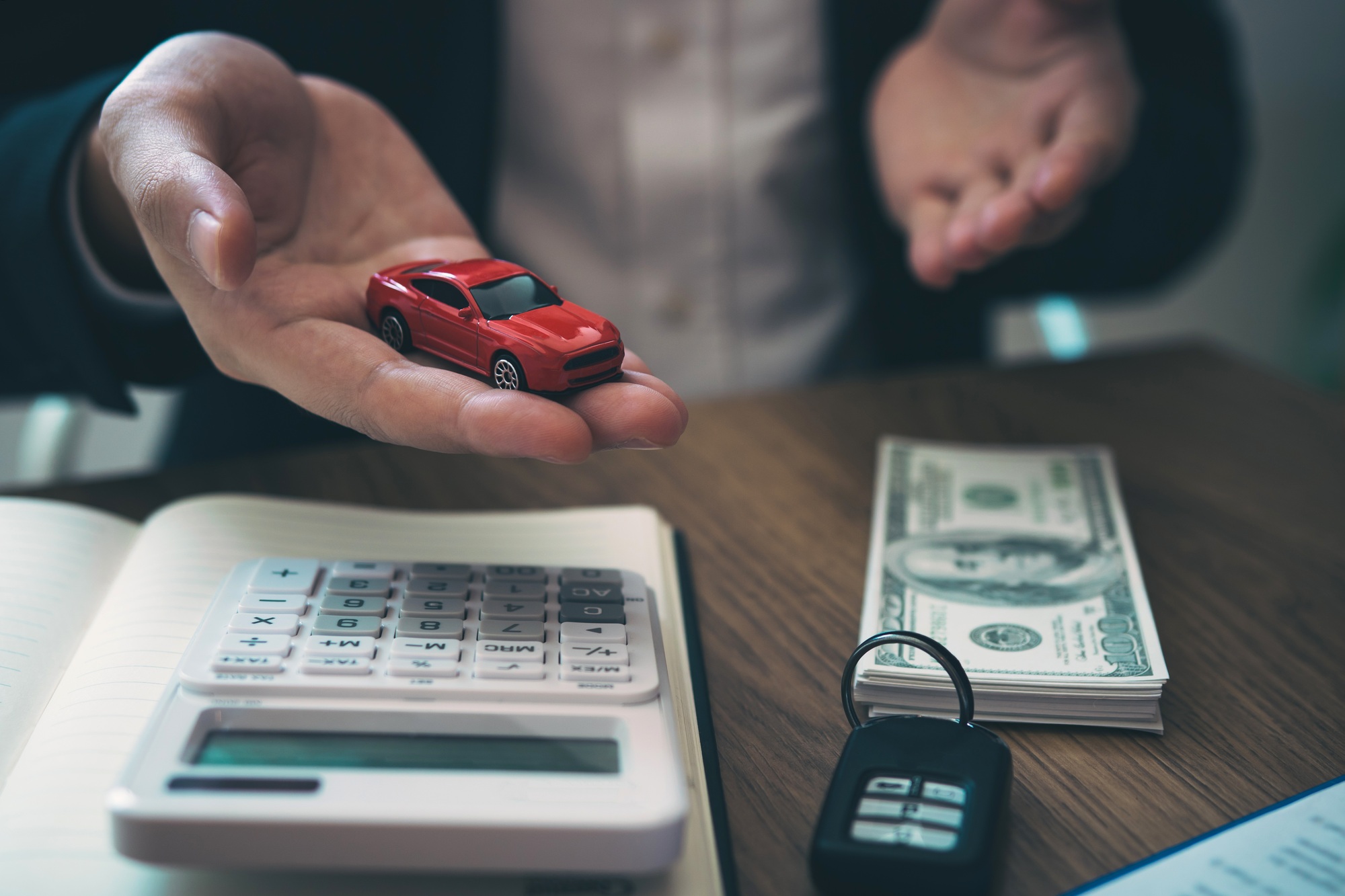 Sales car agent explains about the contract to buy a new car to the customer