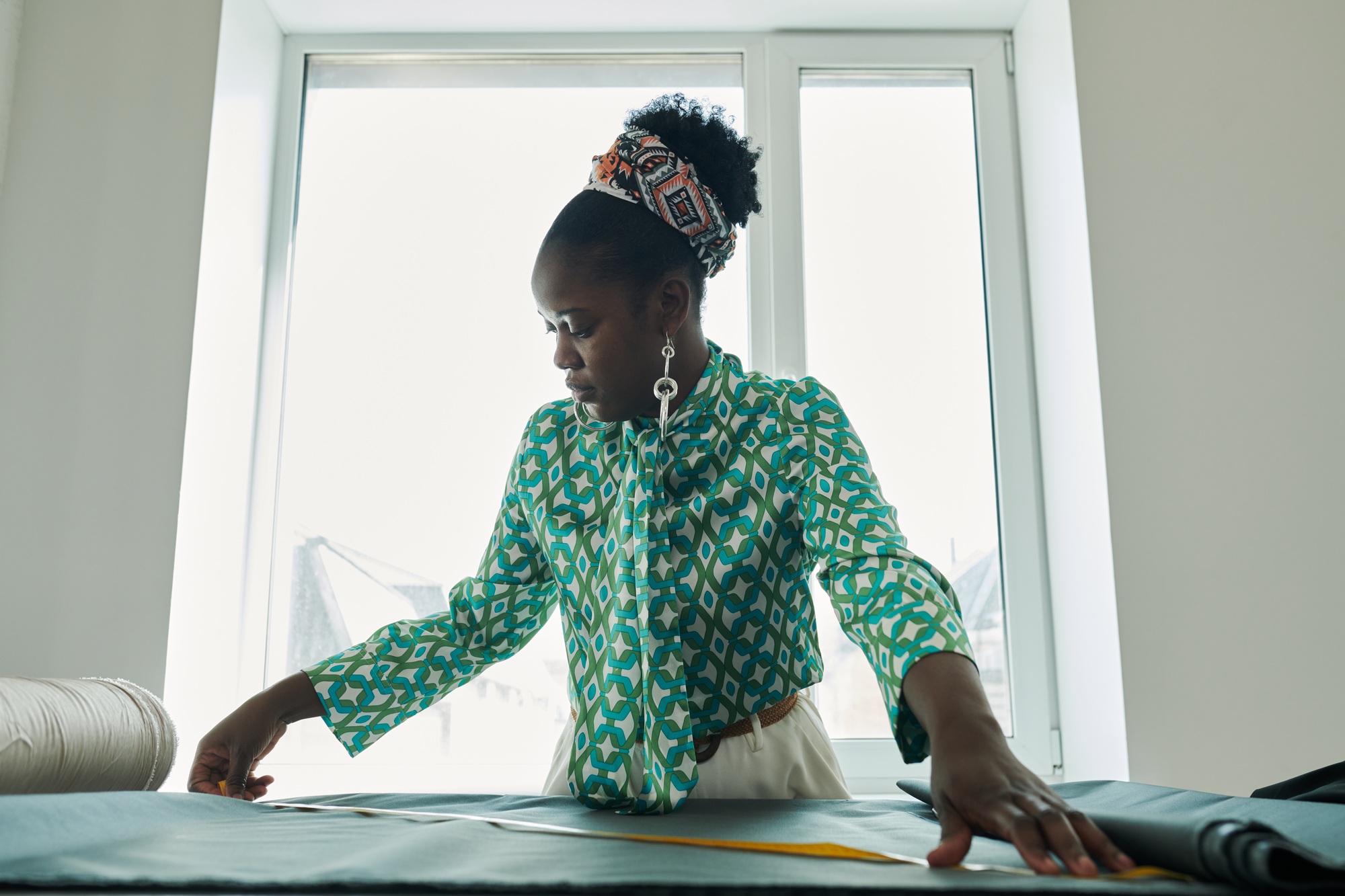 Seamstress measuring piece of textile