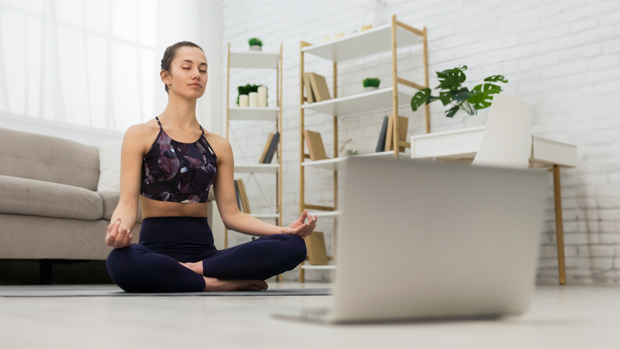 Self learning. Woman using laptop to training yoga