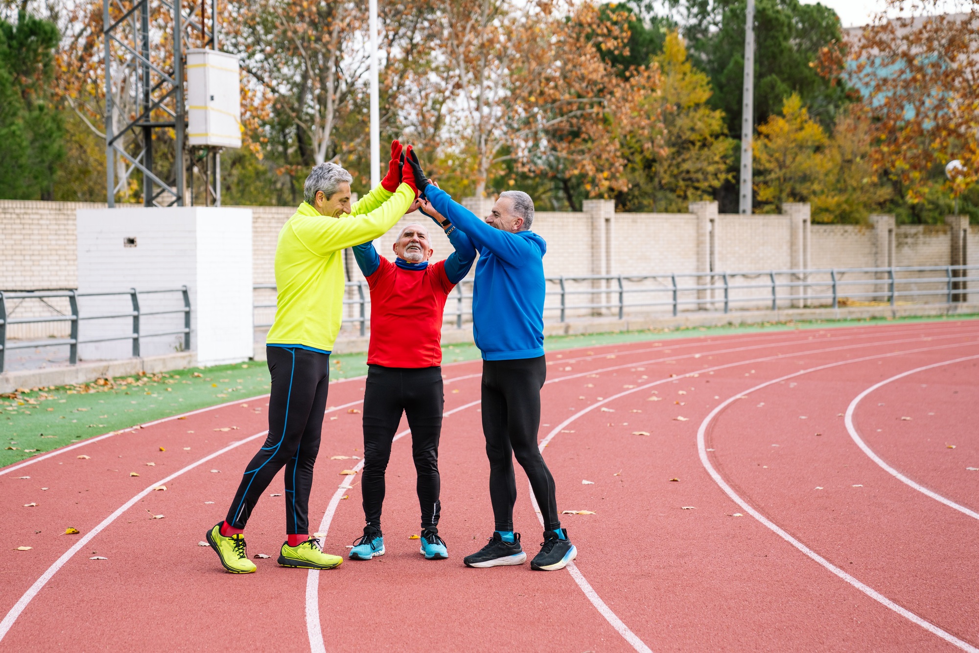 Senior Athletes Celebrating Teamwork on Track Field
