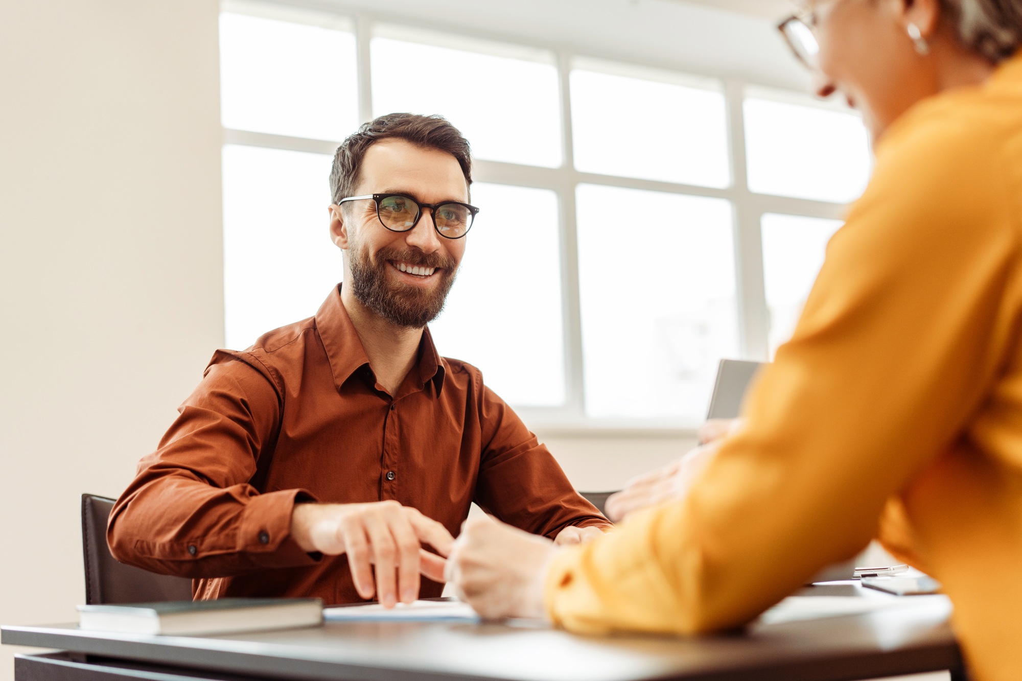 Senior business woman, employer listening smiling candidate at job interview. Human resources