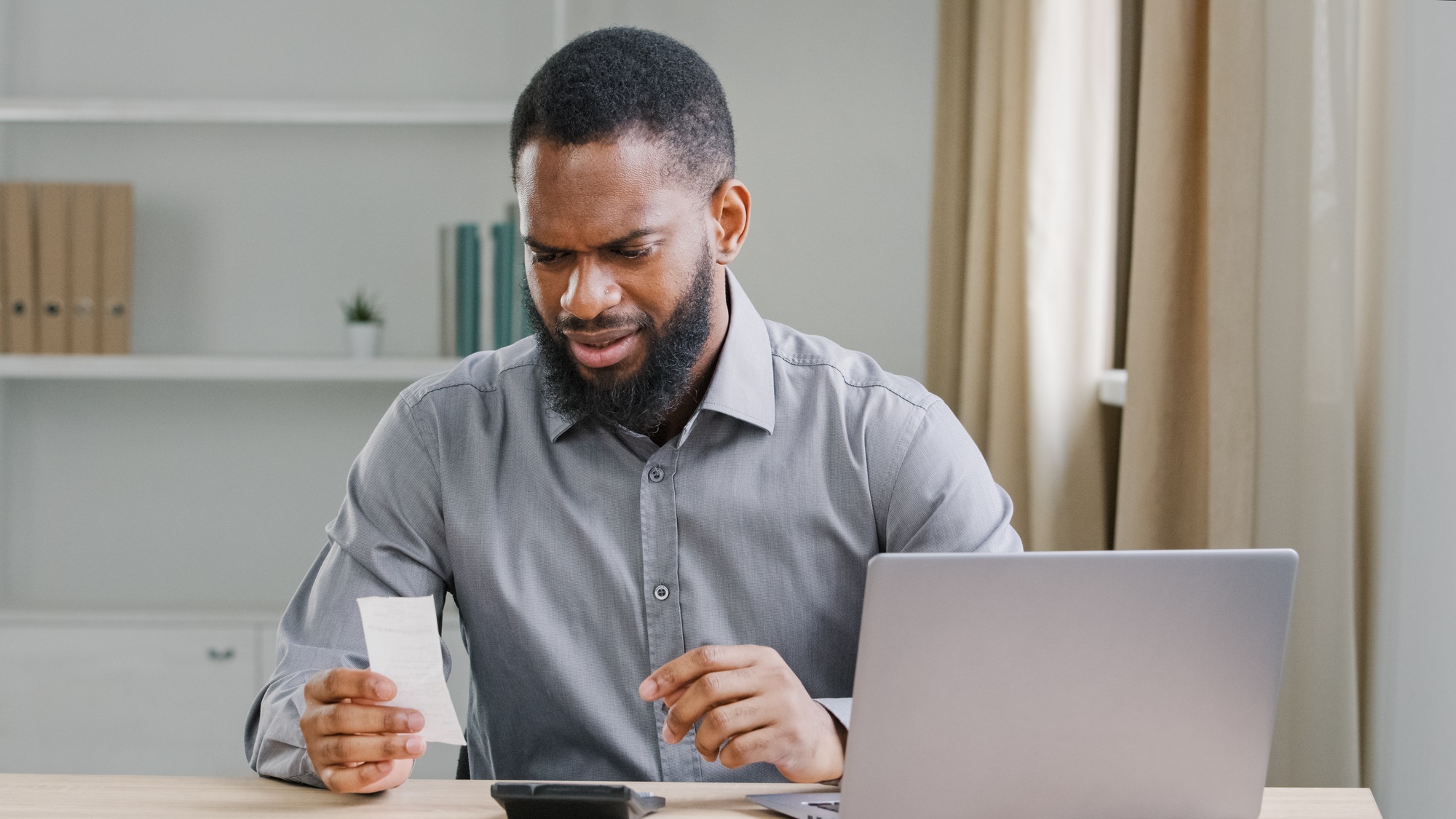 Serious African American ethnic man bookkeeper bearded businessman financial analyst manage business