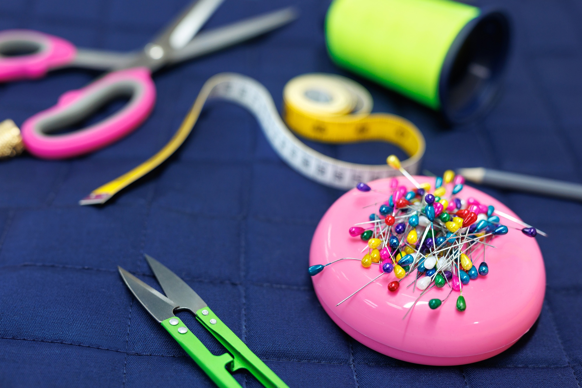 Sewing supplies on a blue background. View from above.