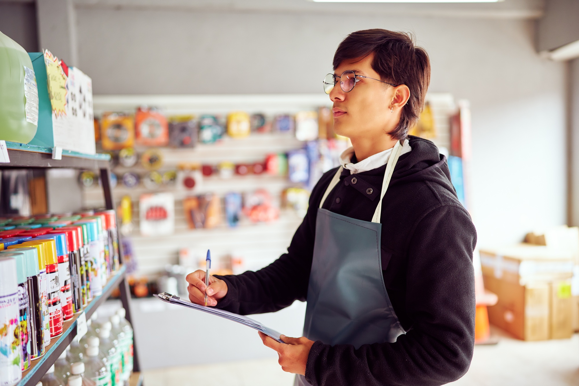 Shop assistant checking stock and inventory in hardware store