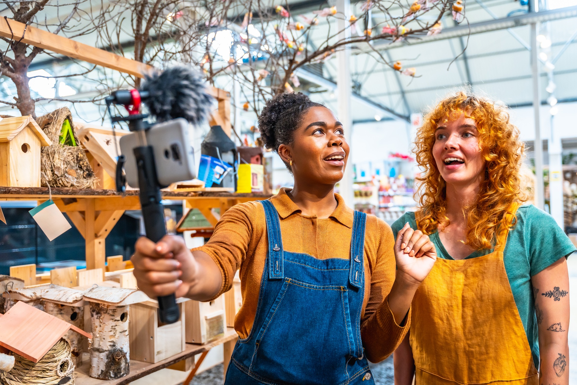 Shop assistants filming video for social media marketing campaign