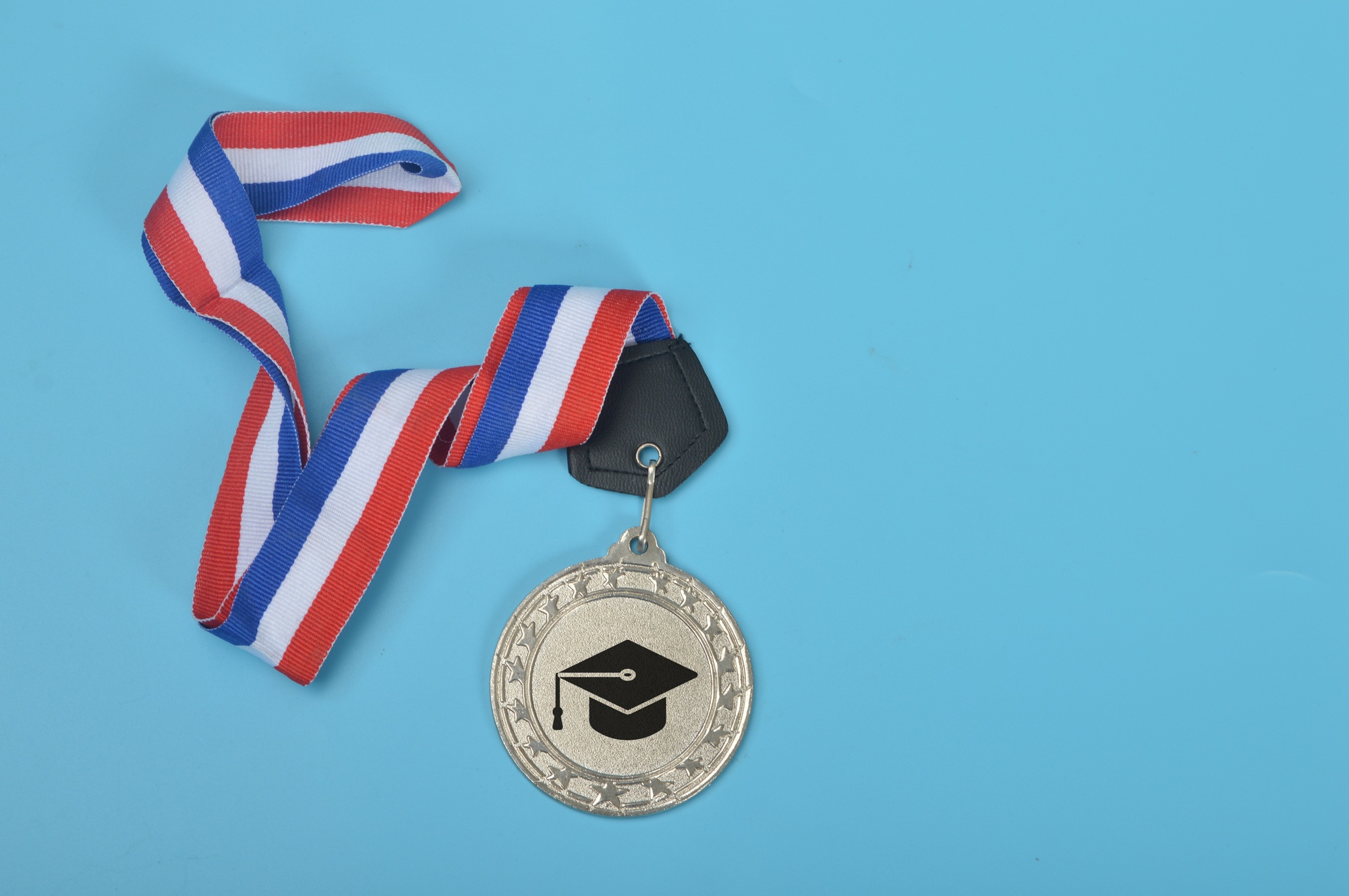 Silver medal with graduation hat symbol. Education and success symbol.