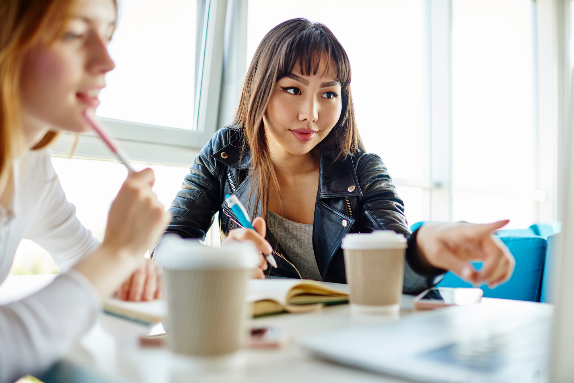 Skilled female colleagues creating content