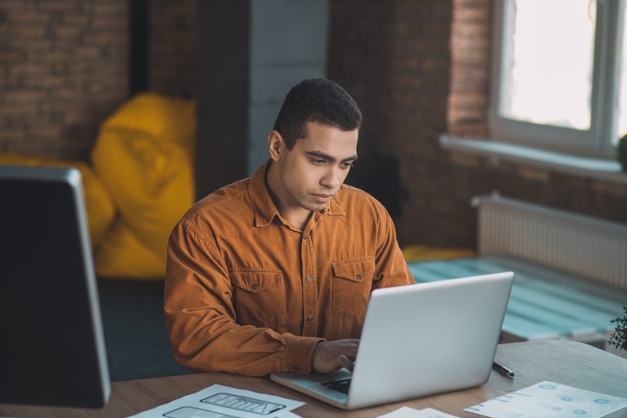 Smart handsome man typing on his laptop