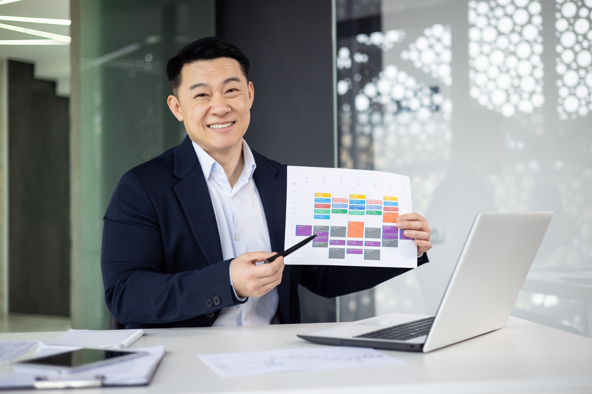 Smiling businessman presenting project schedule in office