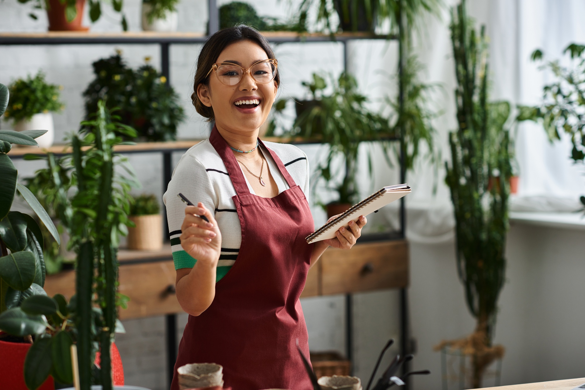 Smiling plant store owner takes inventory