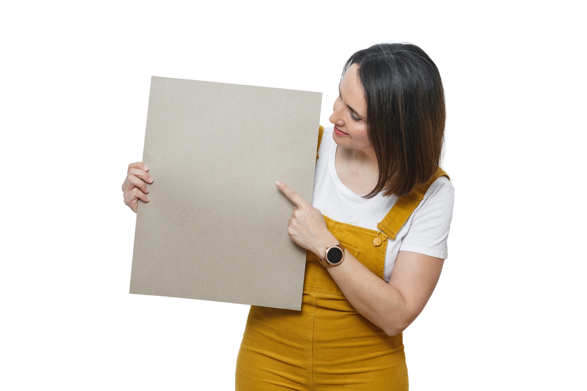 Smiling woman in yellow jumpsuit holding sign for text in bright setting