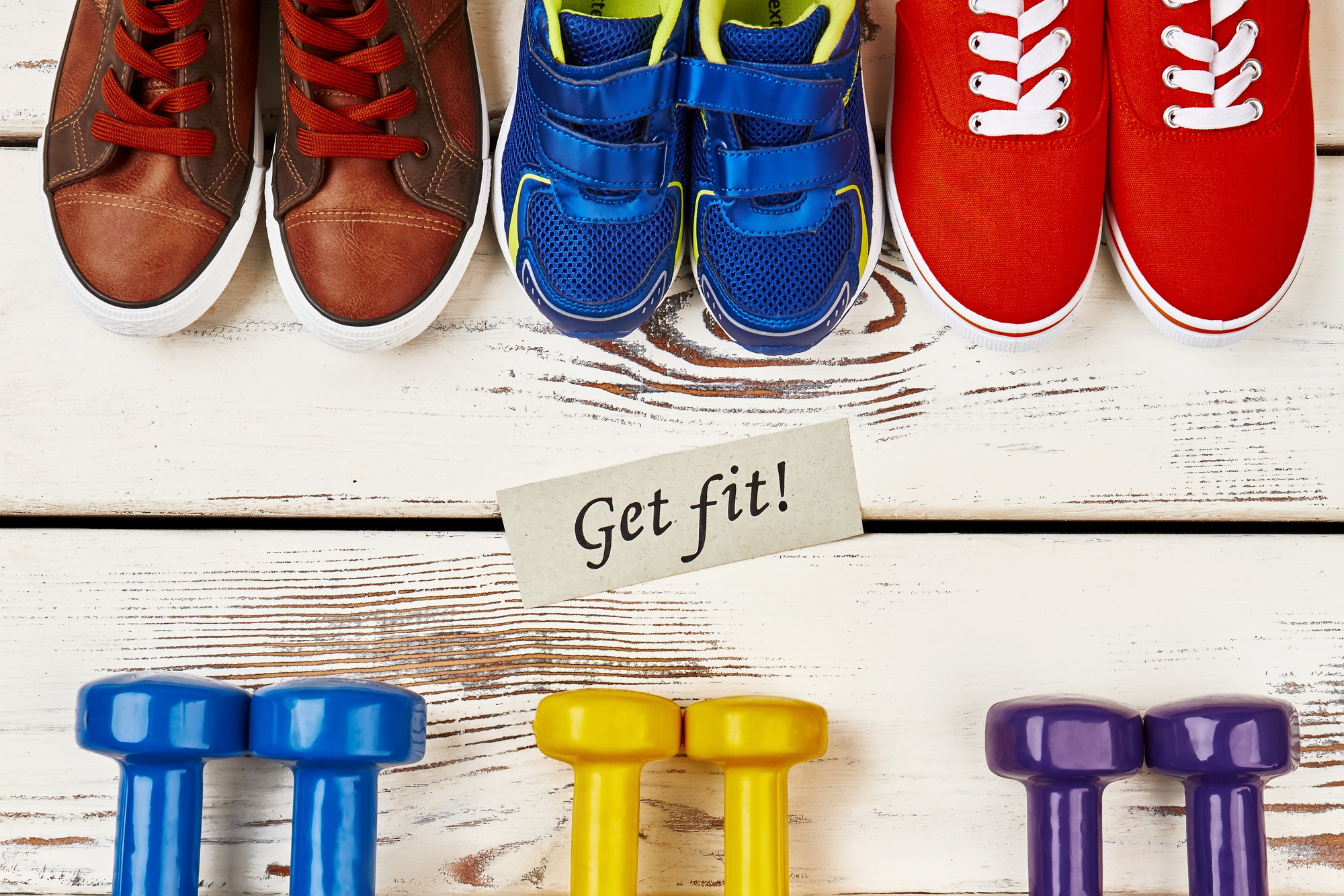Sneakers, dumbbells and motivation card